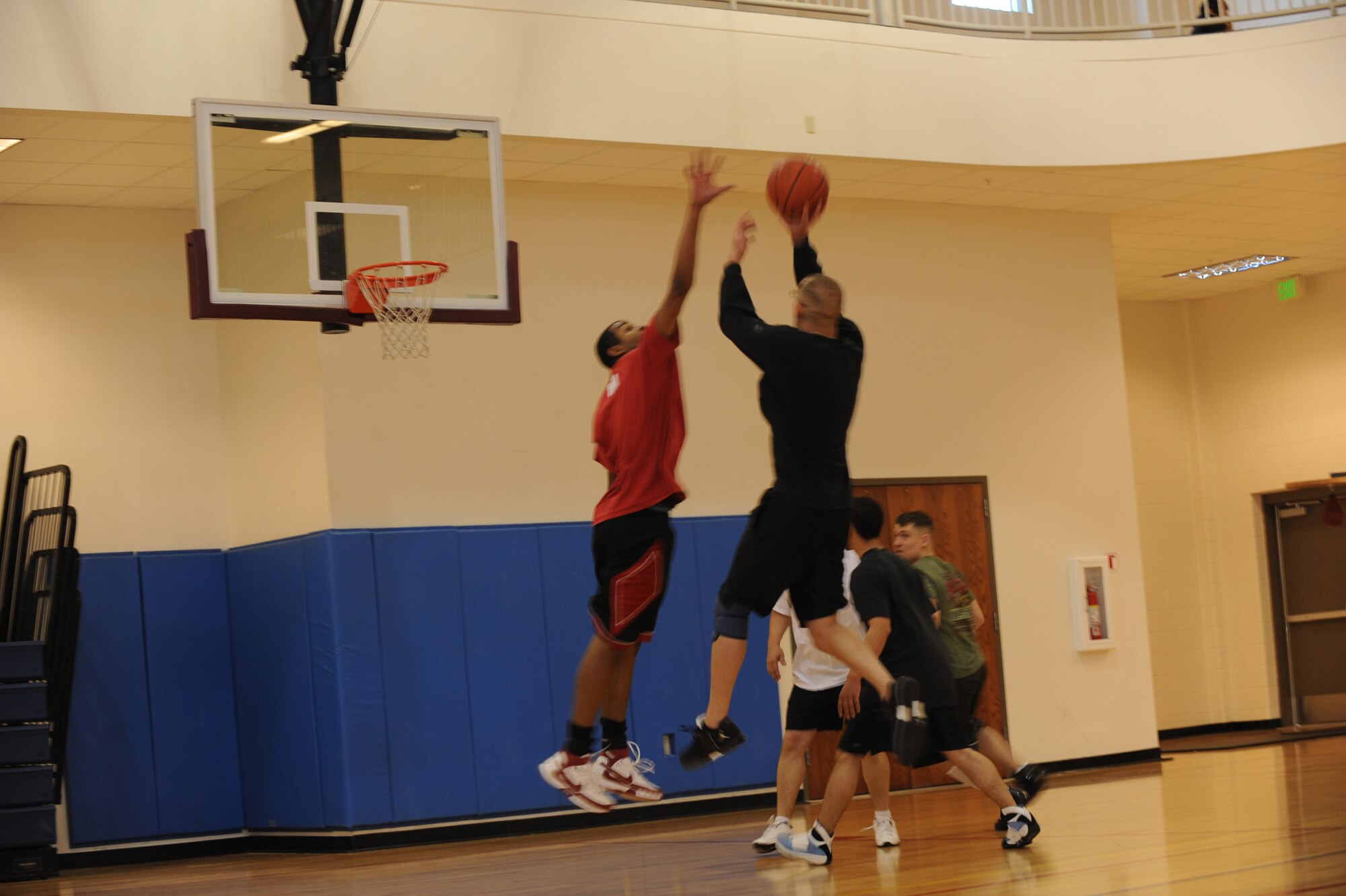 BUCKLEY AIR FORCE BASE, Colo. -- Marine Corps Staff Sgt. Joseph Barotti, Marine Air Control Squadron 23, shoots a fadeaway while Staff Sgt. Alfred Davis with the 4th Manpower Requirements Squadron, tries to block the shot during the 3 on 3 Hoops Classic at the base Fitness Center Jan. 27. (U.S. Air Force by Airman 1st Class Marcy Glass)