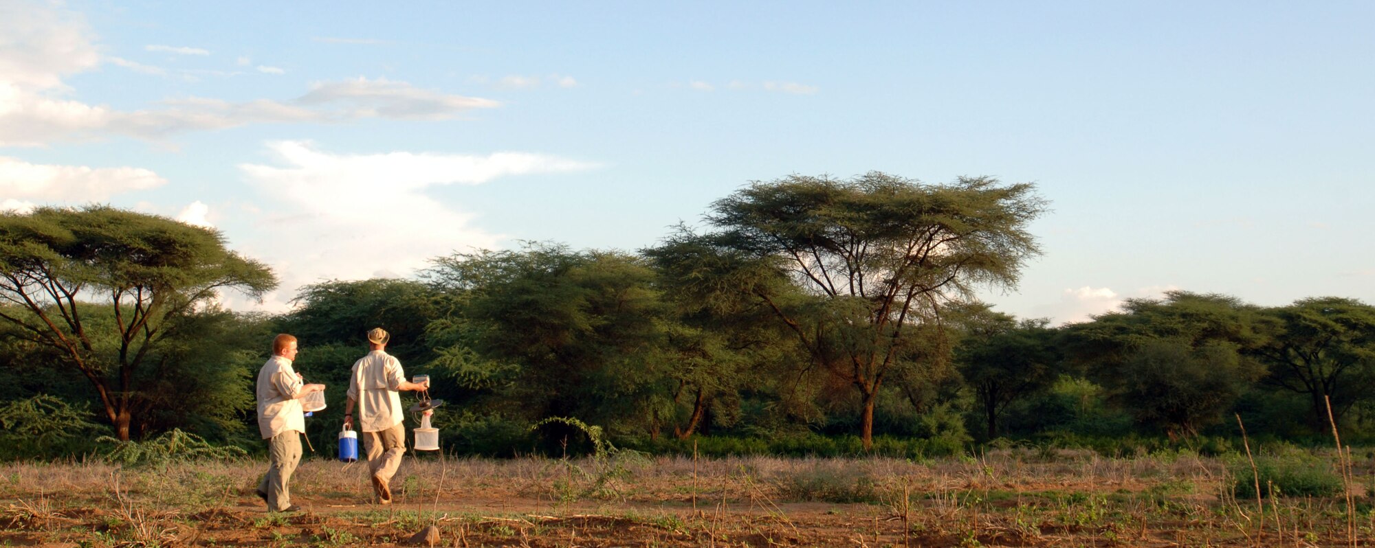 Maj. Keith Blount (right) and 1st Lt. Earl Thomas, entomologists assigned to Brooks-City Base, Texas, take sand fly traps out into a Kenya field Jan. 8. The two Air Force officers were members of a military team that traveled to Africa to obtain information in an effort to aid in the prevention and treatment of Leishmaniasis. (U.S. Air Force Photo By Senior Airman Josie Kemp) 