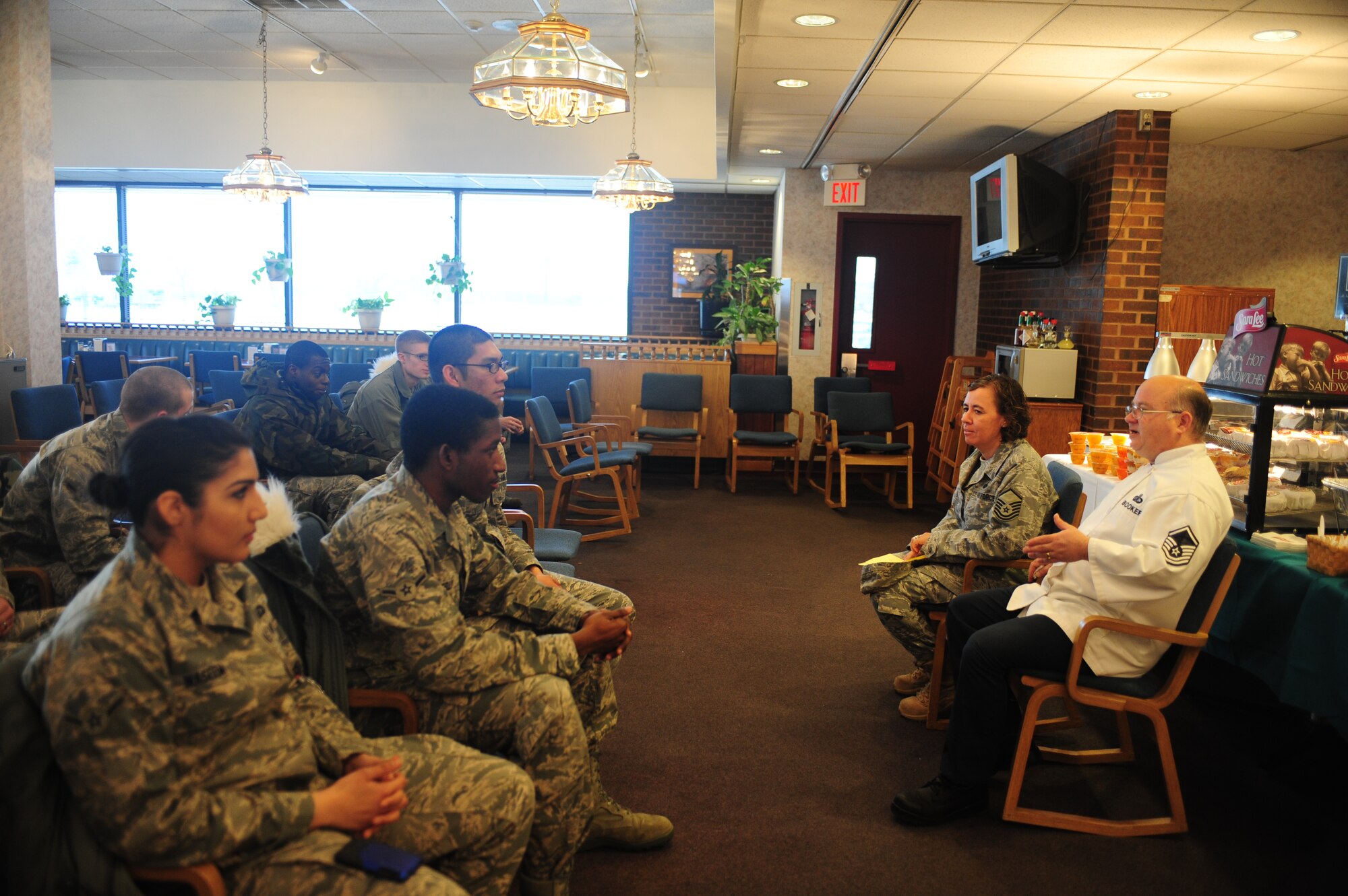 ELLSWORTH AIR FORCE BASE, S.D. -- (Right to left) Master Sgt. David Booker, 28th Force Support Squadron Bandit Inn Dining Facility manager and Master Sgt. Deborah Bets, 28 FSS Bandit Inn co-manager, talk with Airmen about the taste-testing and possible new menu items, Jan 27.  The Bandit Inn hosted a taste-testing event for Airmen to help them create a new menu. (U.S. Air Force photo/Airman 1st Class Anthony Sanchelli)
