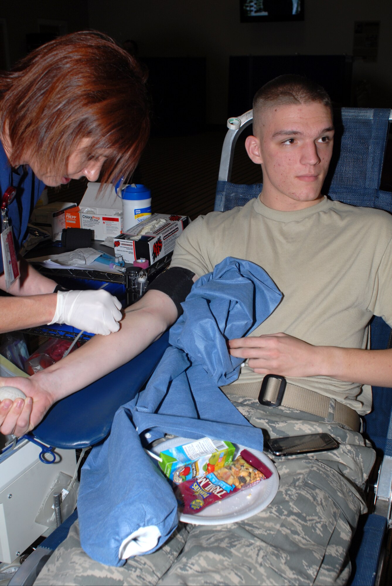 GOODFELLOW AIR FORCE BASE, Texas -- Airman 1st Class Ryan Hamilton, 17th Communications Squadron, looks away as a needle is inserted during a blood drive hosted by the United Blood Services, Jan. 27, 2010. The blood drive was conducted to help supply Wilford Hall at Lackland Air Force Base, Texas. (U.S. Air Force photo/Staff Sgt. Laura R. McFarlane)
