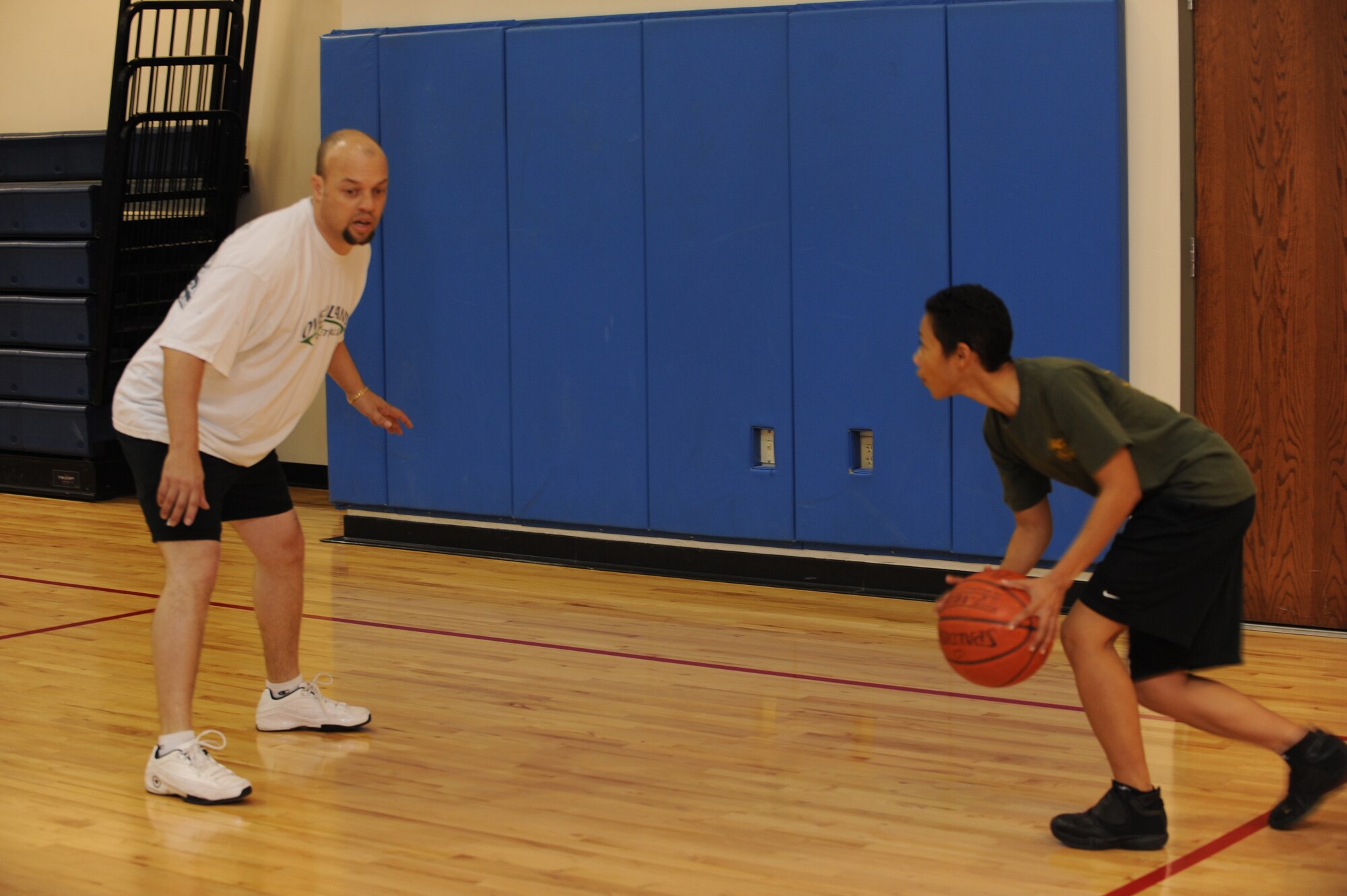 BUCKLEY AIR FORCE BASE, Colo. -- James Tucker guards and his son, Desmond, during the 3 on 3 Hoops Classic at the base Fitness Center January 27. (U.S. Air Force by Airman 1st Class Marcy Glass)