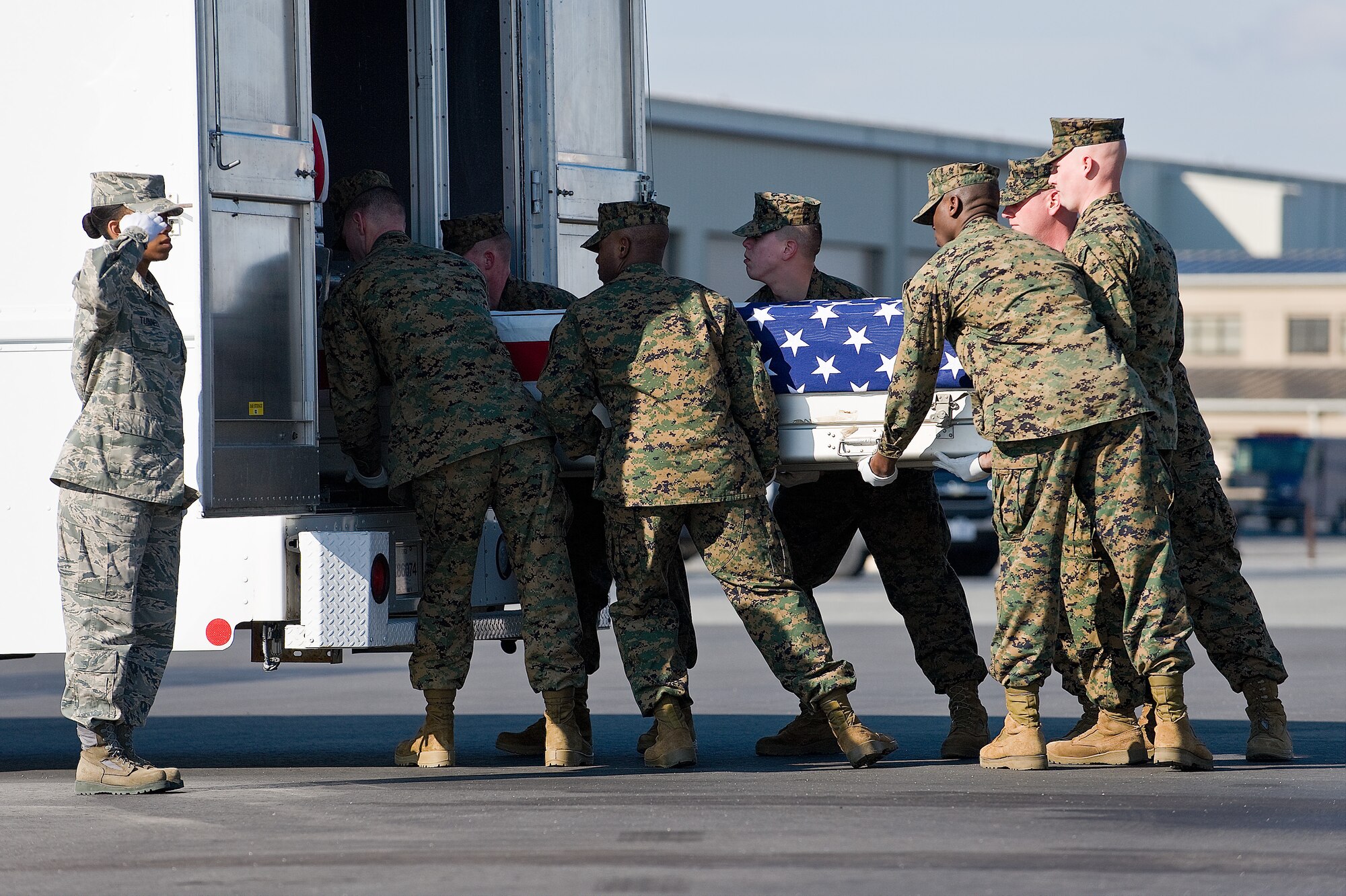 A U.S. Marine Corps team transfers the remains of Marine Corps Lance Cpl. Timothy J. Poole, of Bowling Green, Ky., at Dover Air Force Base, Del., January 27. Lance Cpl. Poole was assigned to 1st Battalion, 3rd Marine Regiment, 3rd Marine Division, III Marine Expeditionary Force, Kaneohe Bay, Hawaii. (U.S. Air Force photo/Roland Balik)