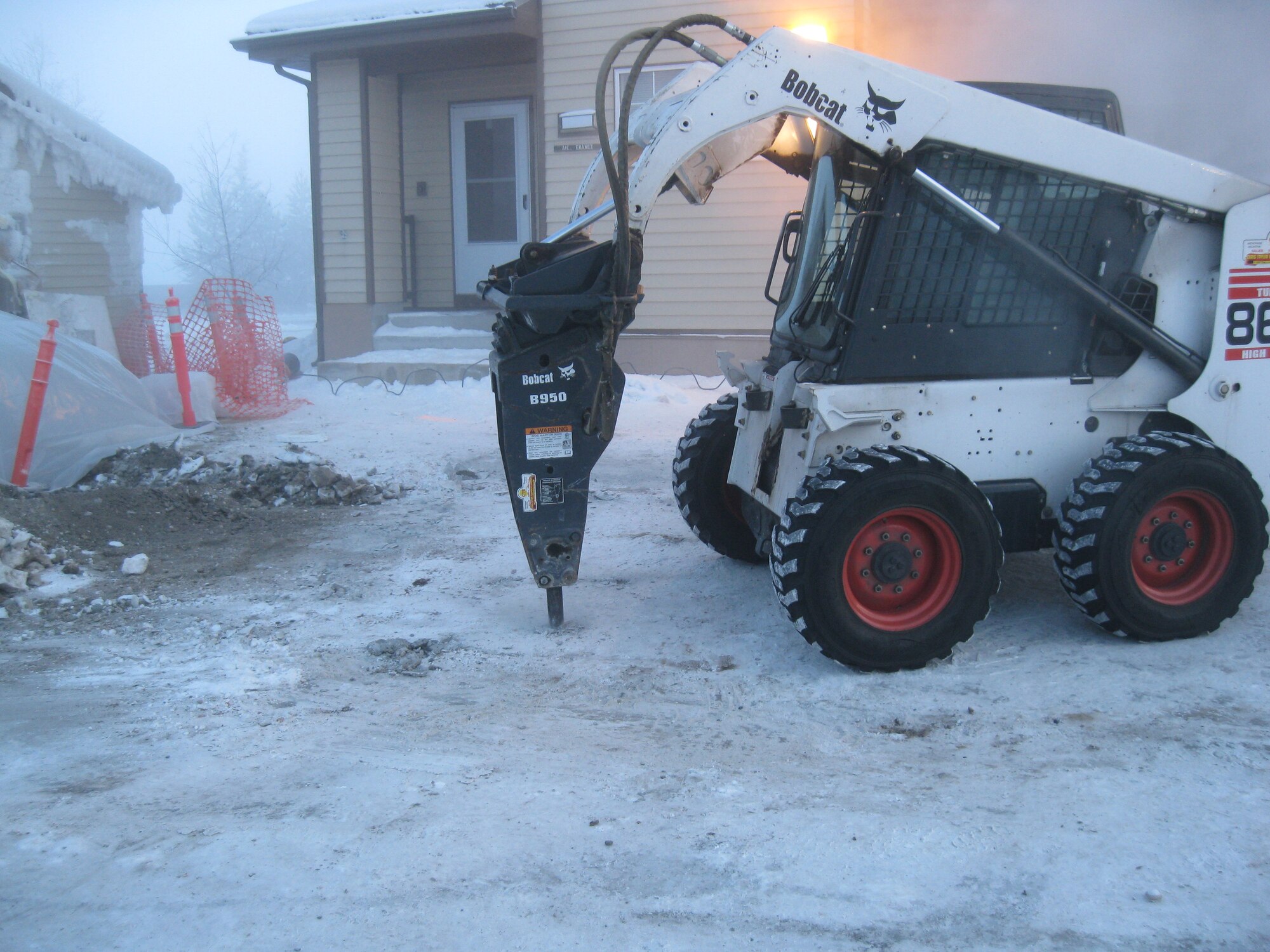 A 354th Civil Engineer Squadron Airman operates the drill Jan. 12, 2010, on Eielson Air Force Base. The Kodiak Street construction restored heat to 16 housing units that had lost their heating ability due to a leak in a pipeline. They worked in temperatures as low as 44 degrees below. They are from the 354th CES snow barn flight. (U.S. Air Force photo/Tech. Sgt. Manuel Lara)