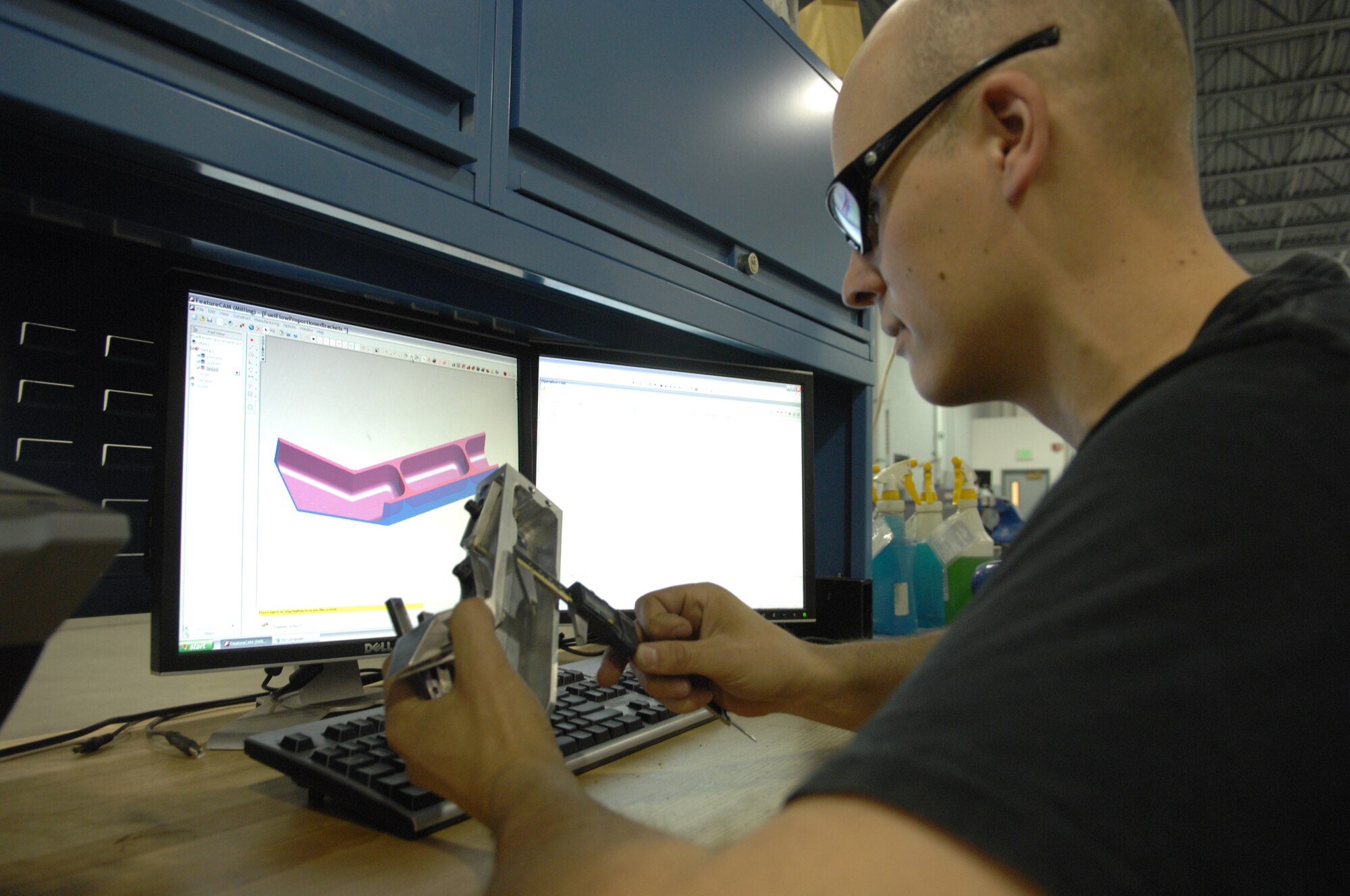Staff Sgt. Joshua Osvold uses a computer aided design and manufacturing program to design an aircraft part. The aircraft metals technology section manufactures parts using a machine by hand or using a computer controlled machine. Sergeant Osvold is a 354th Fabrication flight aircraft metals technology craftsman. (U.S. Air Force photo/Airman 1st Class Rachelle Coleman)