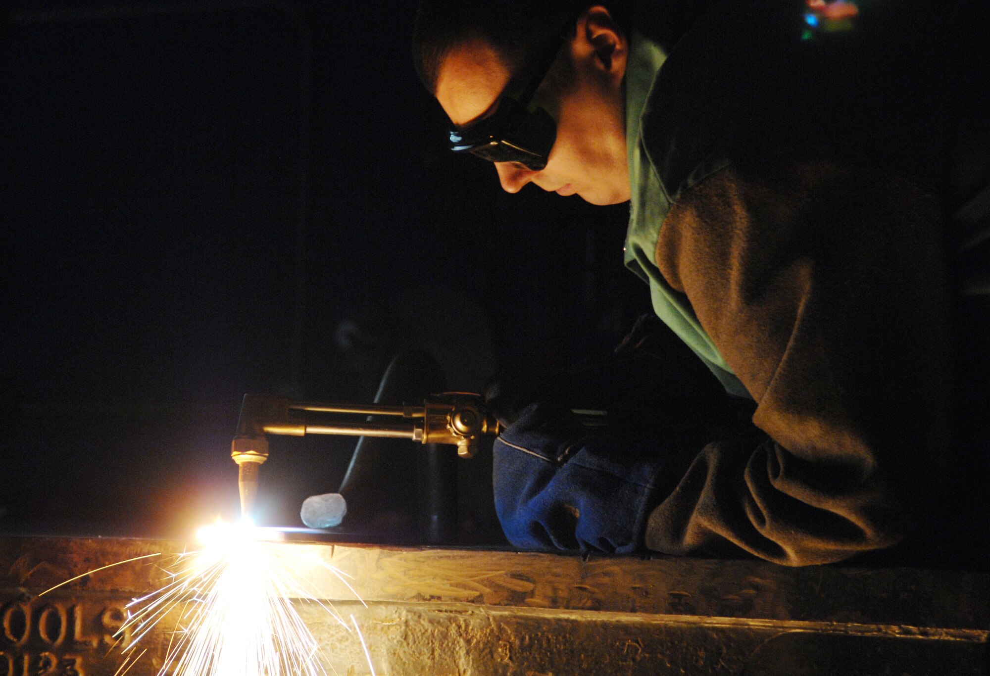 Staff Sgt. Keith Hanson cuts a piece of metal using accetylene Jan. 25, 2010, Eielson Air Force Base, Alaska. The aircraft metals technology section inspects, repairs and manufactures aircraft parts and support equipment that is made of metal. Sergeant Hanson is the 354th Fabrication flight aircraft metals technology assistant flight chief. (U.S. Air Force photo/Airman 1st Class Rachelle Coleman)
