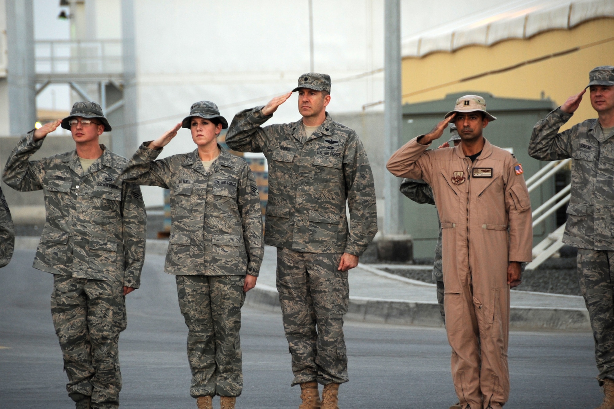Members of the 380th Air Expeditionary Wing salute during retreat at an undisclosed location in Southwest Asia on Jan. 22, 2010.  Airmen from across the wing join every week to pay respect during retreat. (U.S. Air Force photo/Senior Airman Jenifer H. Calhoun/Released)
