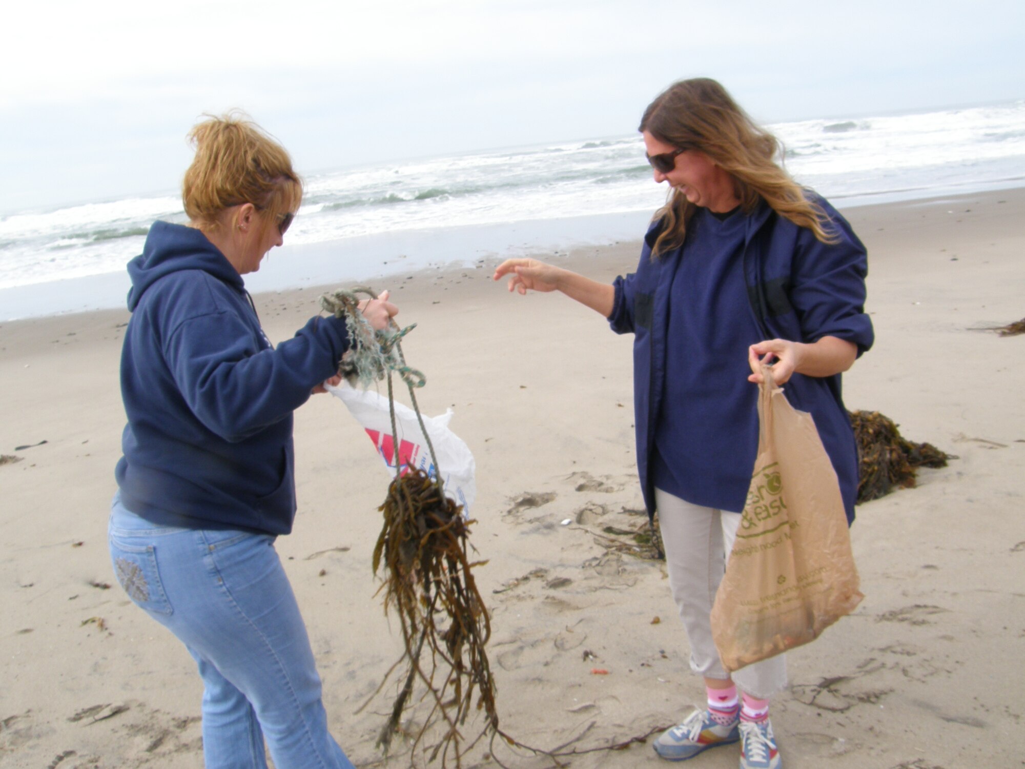 VANDENBERG AIR FORCE BASE, Calif. -- Margie Burnett and Petra Ostrov, of the Vandenberg Home-school Inclusive Partnership, attempt to remove a rope tangled in kelp at Wall Beach here Monday, Jan. 25, 2010. The team of Vandenberg home-schoolers worked together to remove trash and nine tires from the beach. (Courtesy photo/Vandenberg Home-school Inclusive Partnership)