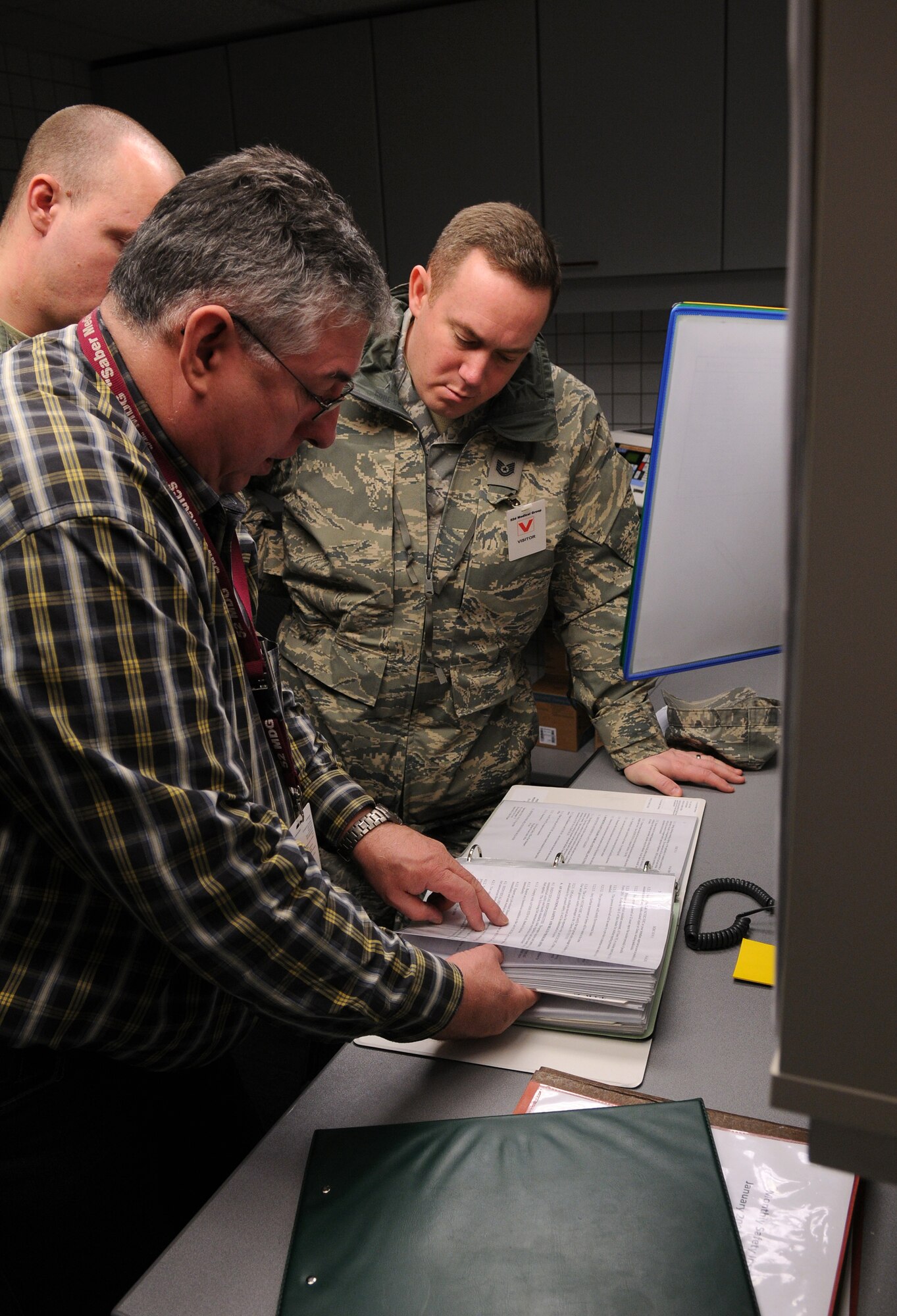 BITBURG ANNEX, Germany -- Mr. Philipp Recktenwald, 52nd Medical Support Squadron safety officer, explains the safety information in a hazardous material binder during the 52nd Medical Group’s annual safety inspection here Jan. 26. Sergeant Blodgett inspected the 52nd MDG to ensure proper safety guidelines are being followed. (U.S. Air Force photo/Senior Airman Nathanael Callon)