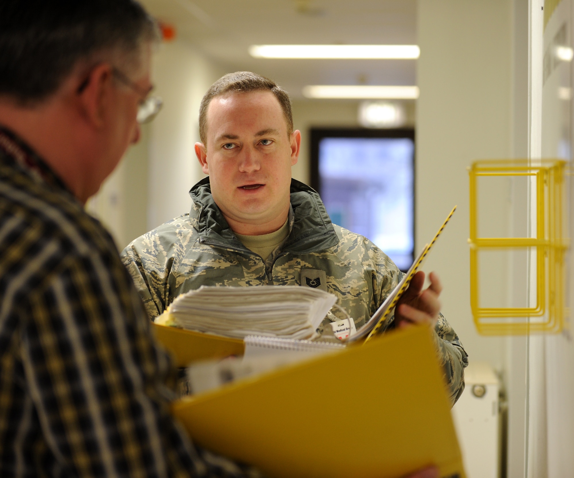 BITBURG ANNEX, Germany -- Tech. Sgt. Anthony Blodgett, 52nd Fighter Wing NCOIC of ground safety, reviews material safety data sheets with Mr. Philipp Recktenwald, 52nd Medical Support Squadron safety officer, to ensure the information is up to date during the 52nd Medical Group’s annual safety inspection here Jan. 26. Sergeant Blodgett reviewed safety continuity binders, training programs and physical safety hazards throughout the medical clinic. (U.S. Air Force photo/Senior Airman Nathanael Callon)