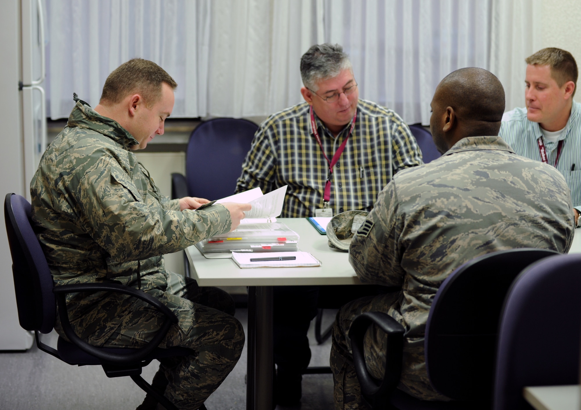 BITBURG ANNEX, Germany -- Tech. Sgt. Anthony Blodgett, 52nd Fighter Wing NCOIC of ground safety, reviews 52nd Medical Group safety binders with Mr. Philipp Recktenwald, 52nd Medical Support Squadron safety officer, during the 52nd MDG’s annual safety inspection here Jan. 26. Sergeant Blodgett reviewed safety continuity binders, training programs and physical safety hazards throughout the medical clinic. (U.S. Air Force photo/Senior Airman Nathanael Callon)