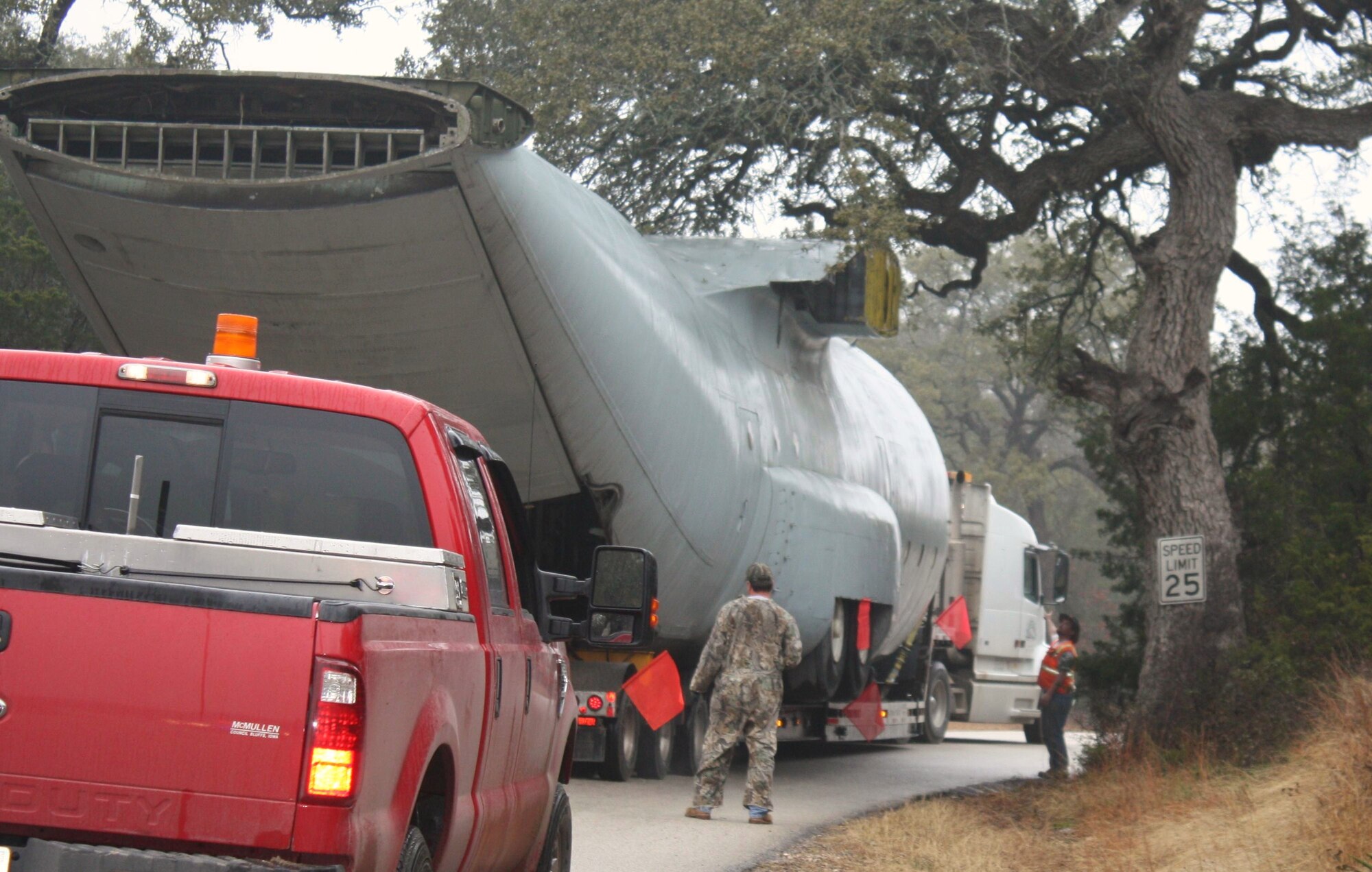 A C-130 training aircraft is the first of three to be moved from the Medical Readiness Site Jan. 13 by the Worldwide Aircraft contractors. The aircraft was moved to Camp Bullis, Texas, and will continue to be used for training once reassembled. The moving process ended Jan. 23, when all three trainer aircraft -  the C-130, the KC135 and the 767 aircraft trainer - were removed after decades of use. (U.S. Air Force Courtesy Photo)