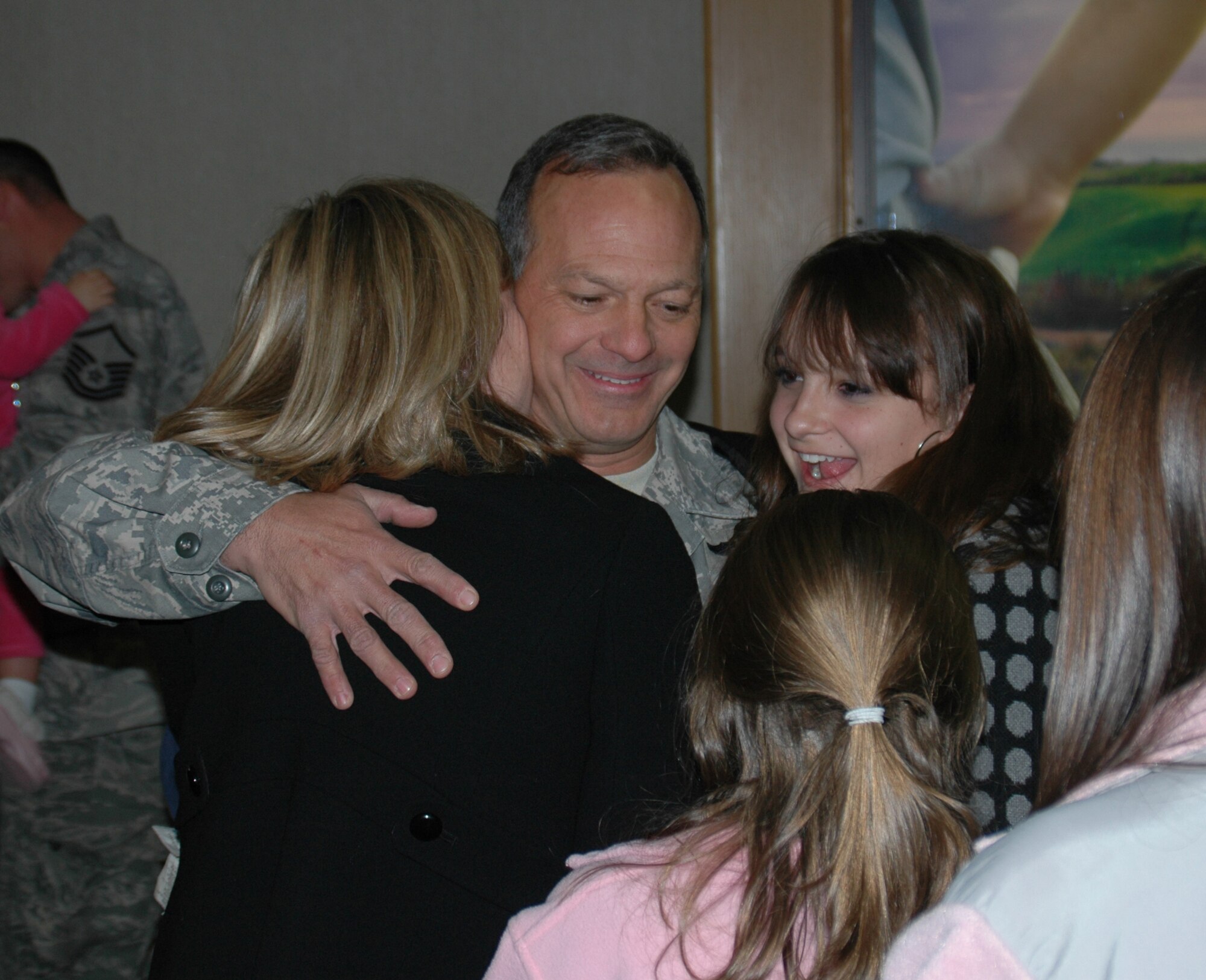 Senior Master Sergeant Abe Clark, a reservist with the 81st Aerial Port Squadron hugs his family after returning from a deployment.  (U.S. Air Force photo by Capt. Wayne Capps) 
