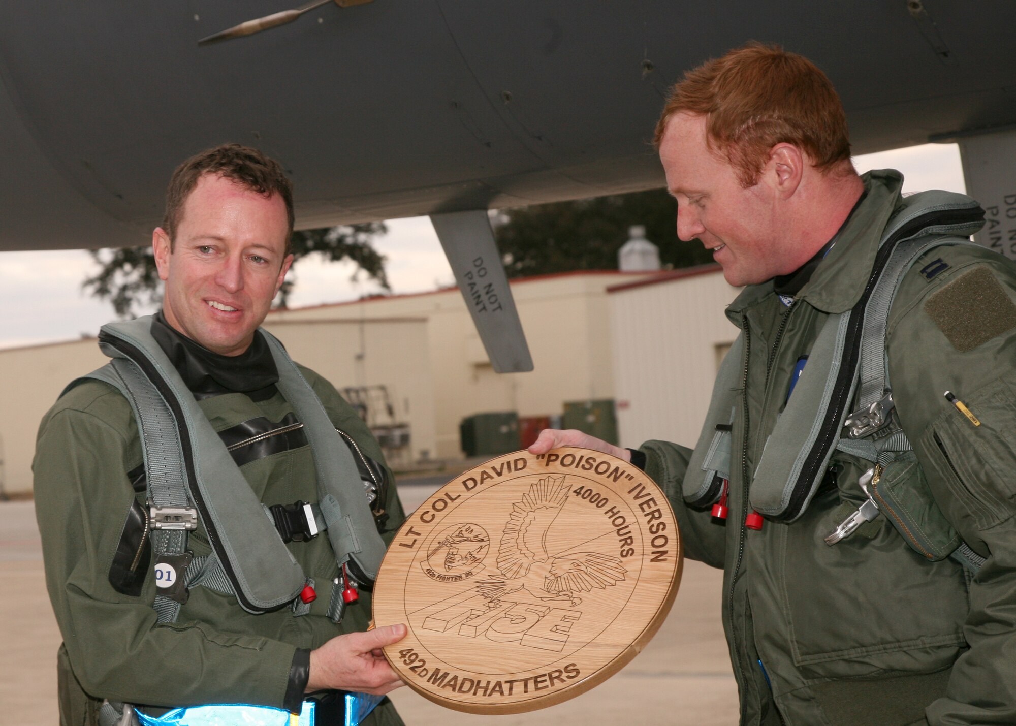 Lt. Col. Dave Iverson, 492nd Fighter Squadron commander receives a memento for his achievement of being the only Strike Eagle pilot on active duty with more than 4,000 flying hours in the airframe at Lackland Air Force Base, Jan. 11.  Col. Iverson spent 17 years flying the F-15E, and those hours have ranged from training other pilots to flying combat sorties in operations Northern and Southern Watch, Deny Flight and Enduring Freedom.  (U.S. Air Force/Robbin Cresswell)