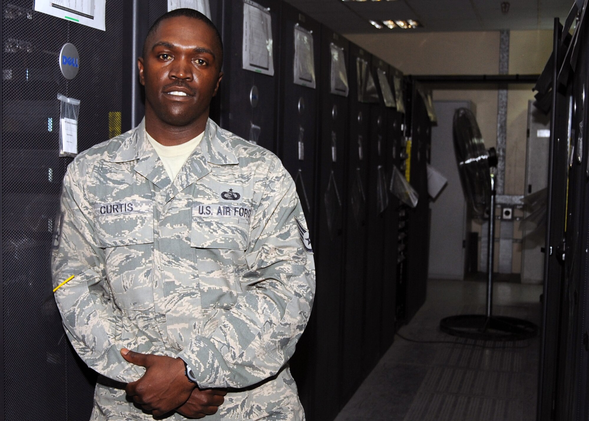 Staff Sgt. Tony Curtis is a network operations technician for the 380th Expeditionary Communications Squadron at a non-disclosed location in Southwest Asia. Here he is pictured at his work area on Jan. 21, 2010.  Sergeant Curtis is deployed from the 83rd Network Operations and Security Center at Langley Air Force Base, Va., and his hometown is Douglas, Ga. (U.S. Air Force Photo/Senior Airman Jenifer Calhoun/Released)