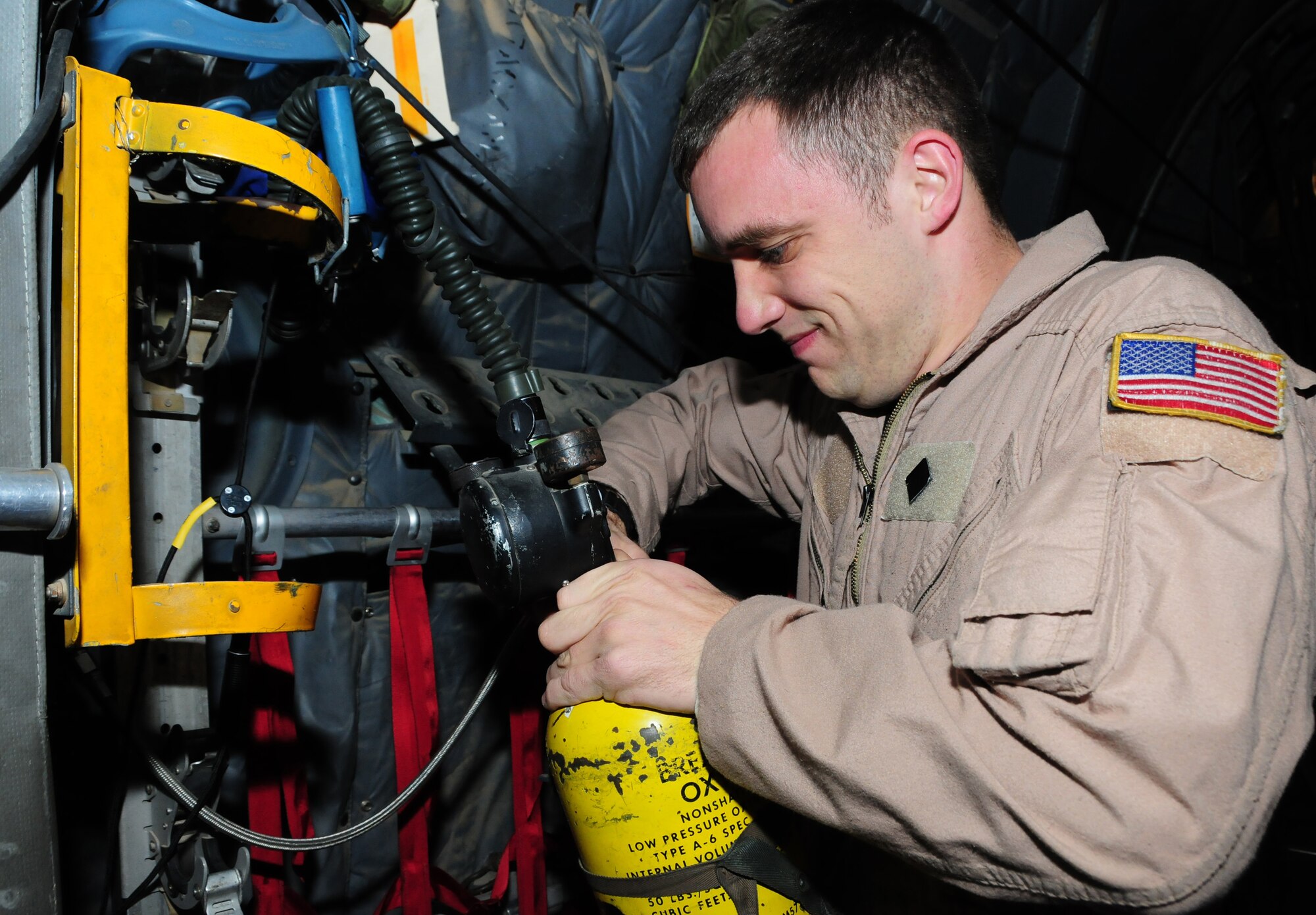 U.S. Air Force Senior Airman Robert Gantz, 737th Expeditionary Airlift Squadron C-130H loadmaster, checks an oxygen tank aboard a C-130 as part of a preflight inspection Jan. 12, 2010 at an air base in Southwest Asia. Airman Gantz, an Akron, Penn., native, is deployed from the 40th Airlift Squadron, Dyess Air Force Base, Texas. (U.S. Air Force photo by Staff Sgt. Lakisha A. Croley/Released) 

