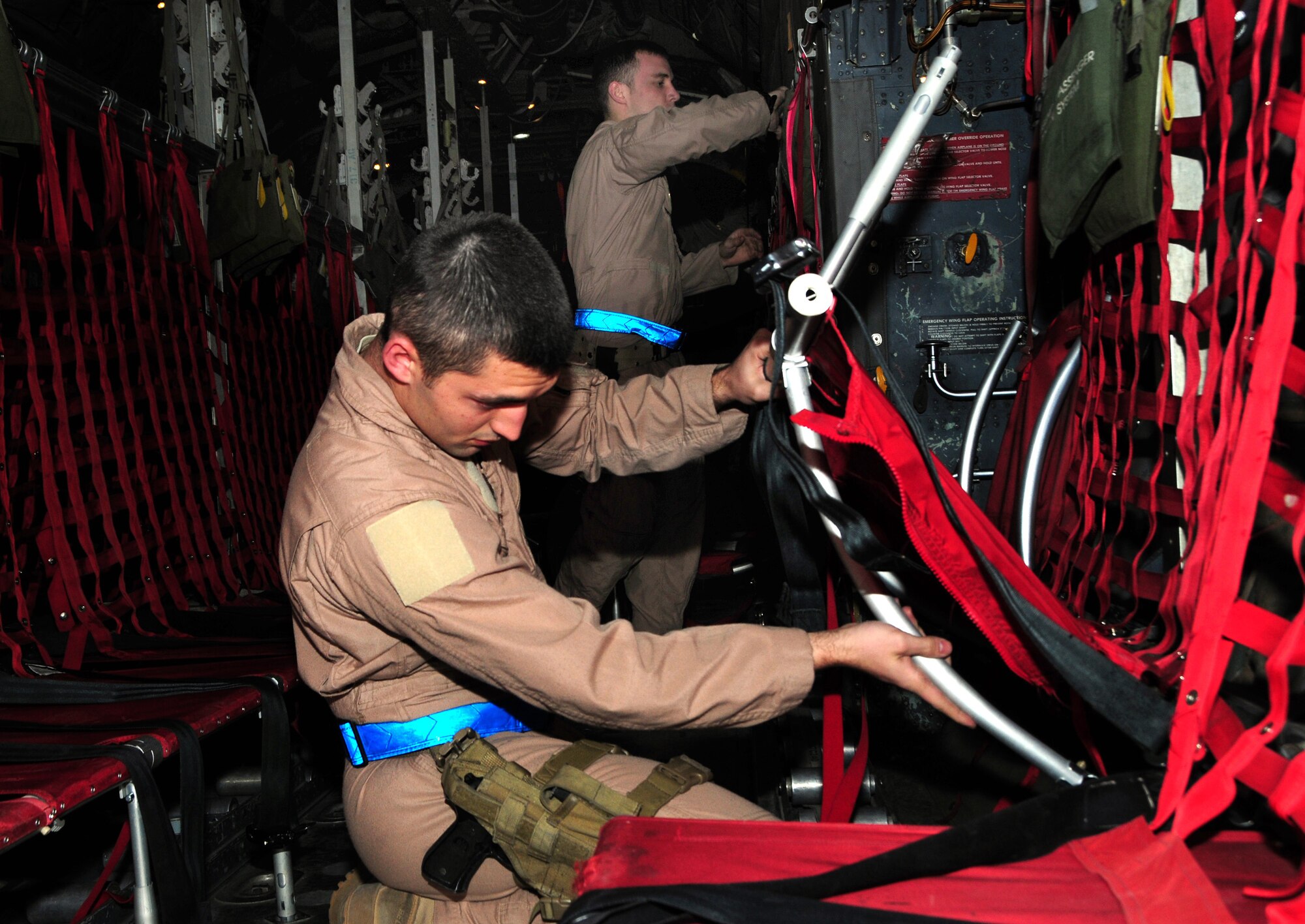 U.S. Air Force Senior Airman Robert Gantz, back, and Airman 1st Class Jonathan Granata, 737th Expeditionary Airlift Squadron C-130H loadmasters, conduct a preflight inspection of  a C-130H cargo bay Jan. 12, 2010 at an air base in Southwest Asia. Airman Gantz, an Akron, Penn., native, and Airman Granta, a Dayton, Ohio, native, are deployed from the 40th Airlift Squadron, Dyess Air Force Base, Texas. (U.S. Air Force photo by Staff Sgt. Lakisha A. Croley/Released)