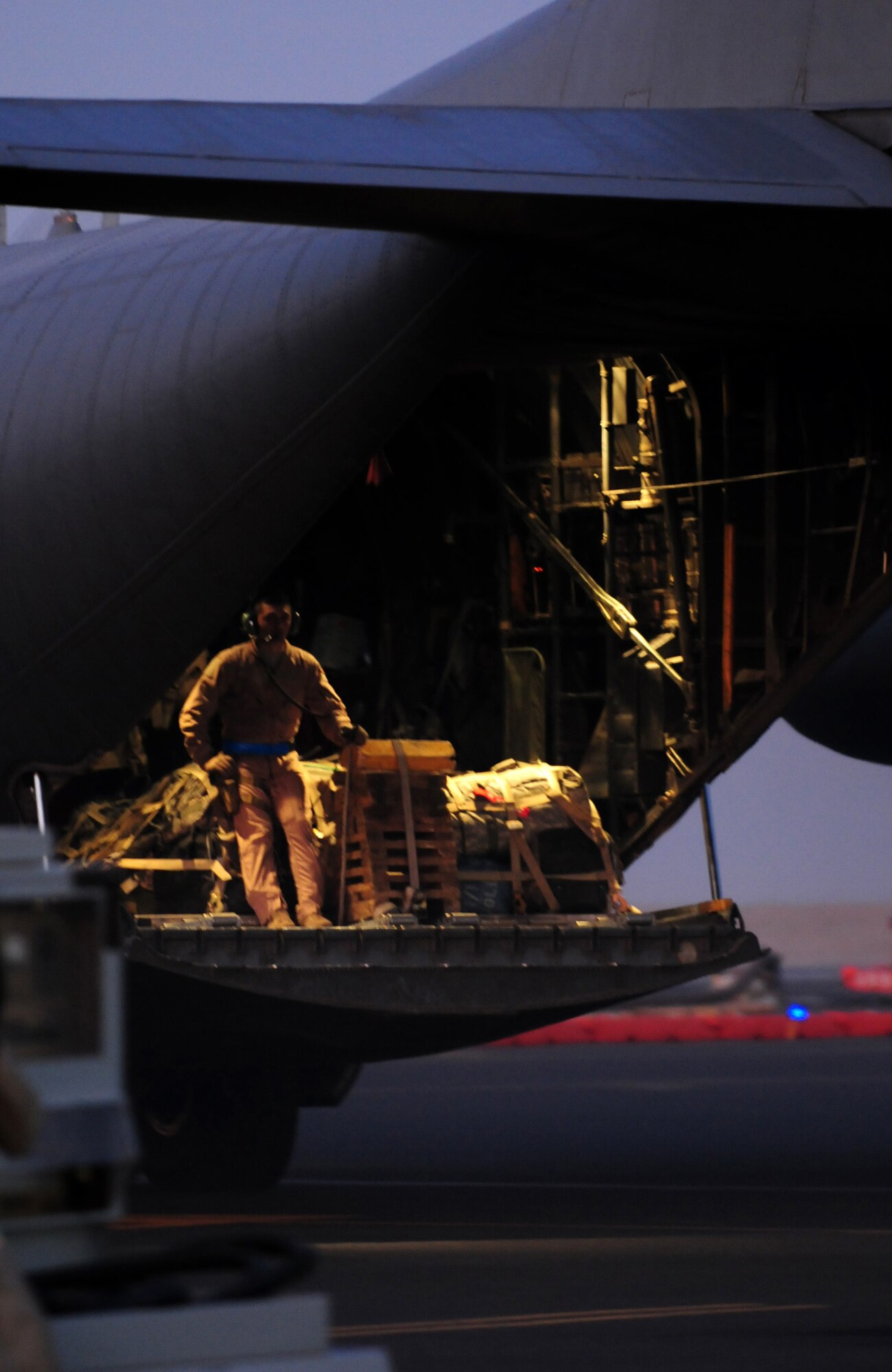 U.S. Air Force Airman 1st Class Jonathan Granata, 737th Expeditionary Airlift Squadron C-130H loadmaster, makes some final adjustments before taxiing down the runway Jan. 12, 2010 at an air base in Southwest Asia. Airman Granata, a Dayton, Ohio,  native, is deployed from the 40th Airlift Squadron, Dyess Air Force Base, Texas. (U.S. Air Force photo by Staff Sgt. Lakisha A. Croley/Released)
