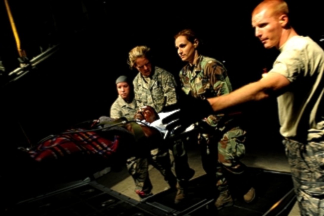 Haitian earthquake patients are transported onto a U.S. Air Force C-130 Hercules aircraft from the 908th Airlift Wing, Maxwell Air Force Base, Ala., by airmen from the 45th Aeromedical Evacuation Squadron, McDill Air Force Base, Fla., at Toussaint L’Ouverture International Airport in Port-au-Prince, Haiti, during Operation Unified Response on Jan. 25, 2010.  Twenty-seven patients are being medically evacuated to Miami International Airport in Fort Lauderdale, Fla.  U.S. Department of Defense assets have been deployed to assist in the Haiti relief effort following a magnitude-7.0 earthquake that hit the city on Jan. 12, 2010.  