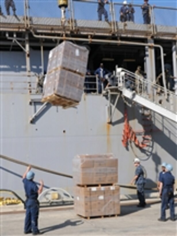 Relief supplies are loaded into the amphibious dock landing ship USS Carter Hall (LSD 50) at U.S. Naval Station Guantanamo Bay, Cuba, to support Operation Unified Response on Jan. 24, 2010.  The naval station is providing logistical support to the Carter Hall while the ship prepares for its humanitarian aid mission.  The Carter Hall will be transporting supplies and Marines from Combat Logistics Battalion 22 to Haiti.  
