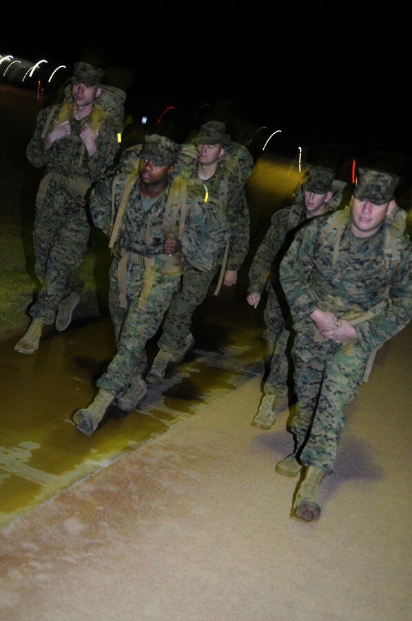 Gunnery Sgt. Fred Suniga, far right, staff noncommissioned officer in charge of the Installation Personnel Administration Center's separations section, leads his Marines on a predawn march at the Marine Corps Air Station in Yuma, Ariz., Jan. 28, 2010, in preparation for the Bataan Memorial Death March. The annual 26.2-mile march, to be held at the White Sands Missile Range, N.M., on March 21, commemorates the nearly 75,000 Americans and Filipinos forced across the hellacious terrain of the Bataan Peninsula to internment camps by the Japanese during World War II.
