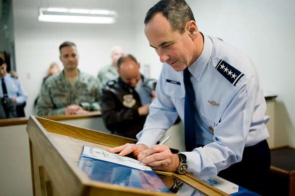 Gen. Raymond E. Johns, Jr., commander of Air Mobility Command, signs a certificate of award recognizing one of four AMC-level Leo Marquez award winners during roll call at the 62nd Aircraft Maintenance Squadron, Silver AMU, Monday. General Johns presented Leo Marquez Award certificates, spoke to annual award winners from the 62nd AMXS and MXS squadrons, and encouraged maintainers to perform well during the upcoming LCAP inspections. (U.S. Air Force Photo/Abner Guzman)