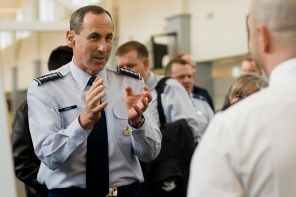 Gen. Raymond E. Johns, Jr., commander of Air Mobility Command, speaks with a civilian employee while visiting McChord's customer service mall Monday. General Johns attended a joint basing briefing, met with McChord Airmen and civilians, and walked through the customer service mall during his tour of the 62nd Airlift Wing headquarters building. (U.S. Air Force Photo/Abner Guzman) 