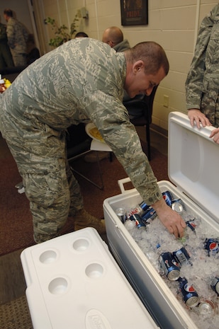 Senior Airman Jamie Anderson reaches for a soft drink here during a free lunch hosted by a group of cadets with Charleston Southern University's Air Force Reserve Officer Training Corps Detachment 772 Jan. 29. The approximately 10 cadets volunteered to feed Airmen with the 437th Aerial Port Squadron as a kind gesture for all their hard work during the Haiti relief effort, serving hotdogs hamburgers, chips, lemonade and soda. Airman Anderson is an air transportation specialist with the 437 APS cargo section. (U.S. Air Force photo/Airman 1st Class Lauren Main)