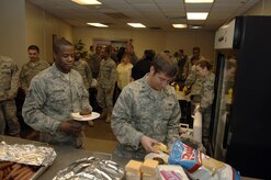 First Lt. Eric Layo, right, and Staff Sgt. Samuel Coleman gather for a free lunch provided by Air Force Reserve Officer Training Corps Detachment 772 cadets from Charleston Southern University here Jan. 29. More than 200 hotdogs and hamburgers were served up by the cadets to feed the hungry aerial port Airmen. The cadets put on the event to show their appreciation for all of the hard work the 437 APS has contributed to the relief efforts in Haiti, with more than 1,300 tons of relief supplies having been shipped. (U.S. Air Force Photo/Airman 1st Class Lauren Main)