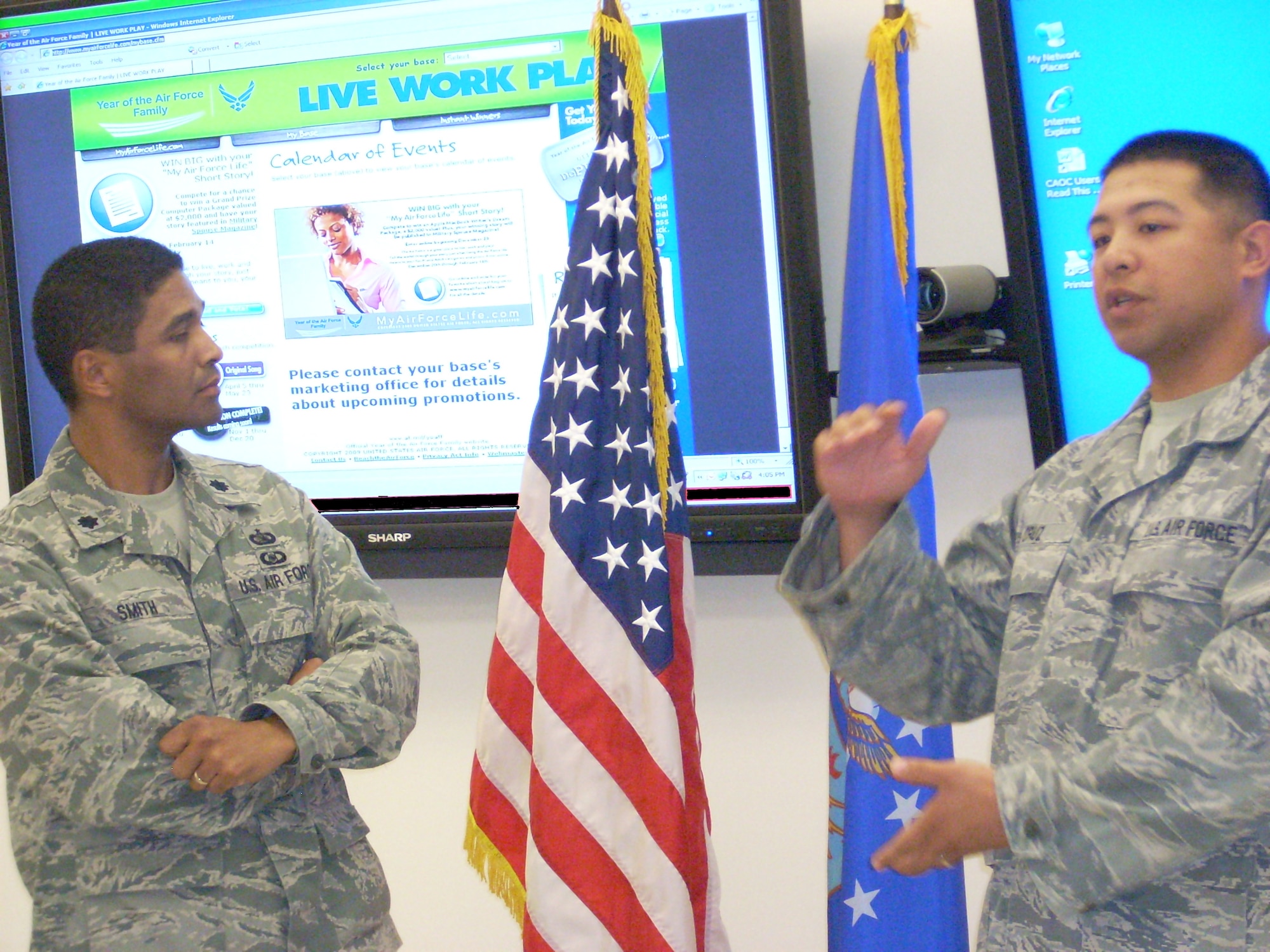 Staff Sgt. Nathan Cruz talks about the T-shirt competition while his squadron commander, Lt. Col. Alexander Smith, looks at the MyAirForceLife.com Web site.  (Photo courtesy of USAF)