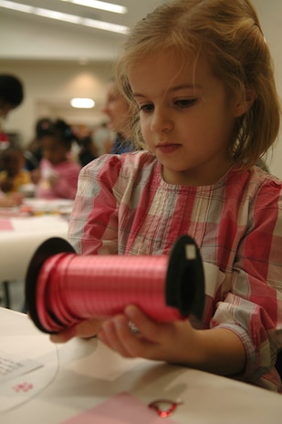 Lily Yengo decorates a valentine for her father during the Quarterly Spouse Appreciation Dinner at the base chapel Jan. 28. The appreciation dinner was hosted by the Airman and Family Readiness Center in conjunction with the base chapel to help the spouses of deployed family members connect and support one another. Lily's father Capt. Chris Yengo, a pilot with the 14th Airlift Squadron, is currently deployed to the Middle East and is due to return home in the spring of 2010. (U.S. Air Force photo/Airman 1st Class Lauren Main)