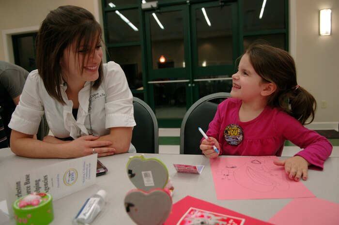 Lizann Viccellio looks on as her daughter Isabel colors a valentine for her father, 1st Lt. Anthony Viccellio at the base chapel during the Quarterly Spouse Appreciation Dinner for spouses of deployed members Jan. 28. Lieutenant Viccellio, a pilot with the 14th Airlift Squadron, is currently deployed to the Middle East and is expected her to return home in the spring of 2010. (U.S. Air Force Photo/Airman 1st Class Lauren Main)