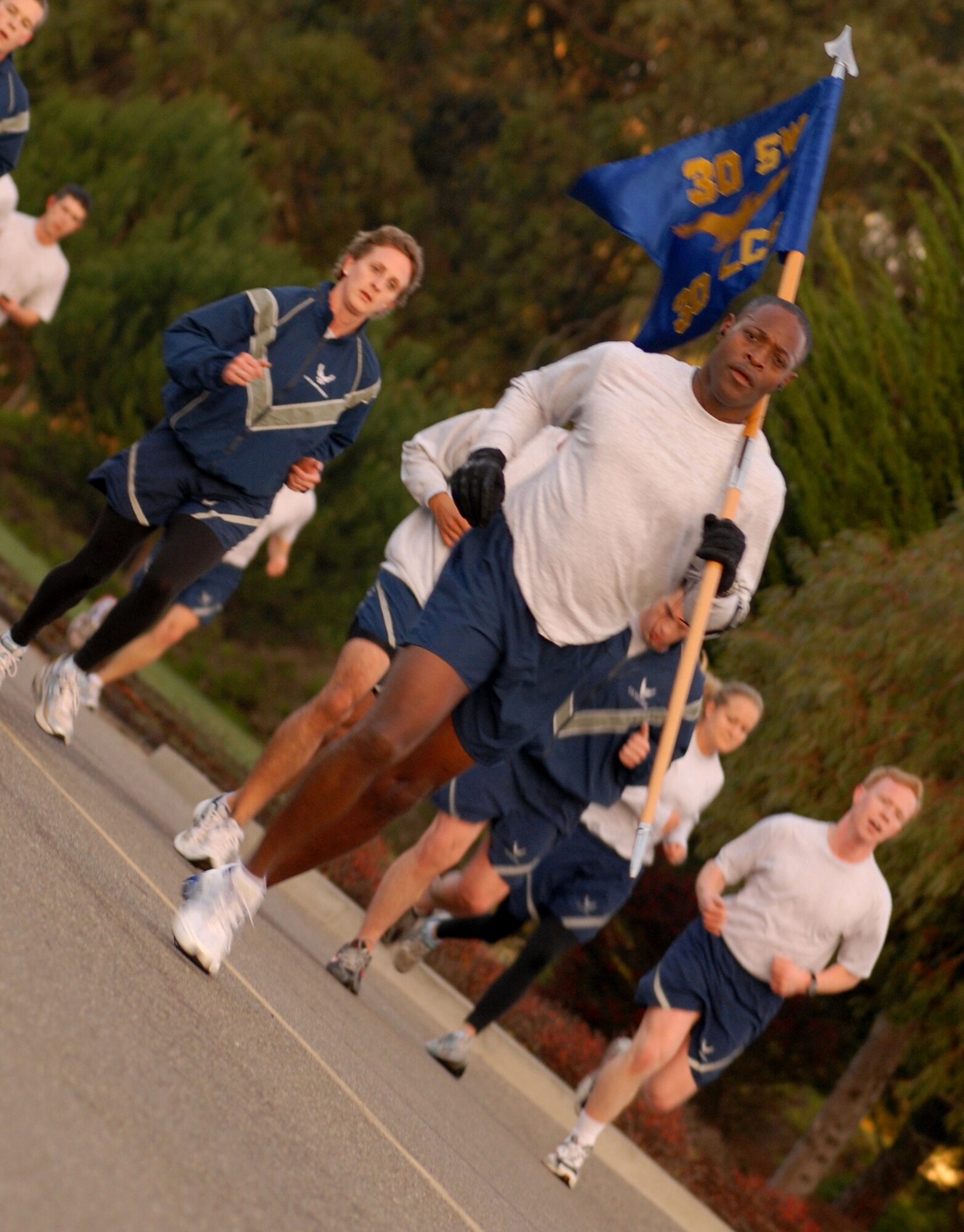 VANDENBERG AIR FORCE BASE, Calif. -- Leading members of the 30th Launch Group during the wing run, Col. Lavanson Coffey, the 30th LCG commander, carries the group's guidon Friday, Jan. 29, 2010, here. The 30th Space Wing Fit-to-Fight Run is held monthly in order to promote a more fit Air Force. (U.S. Air Force photo/Airman 1st Class Kerelin Molina)
