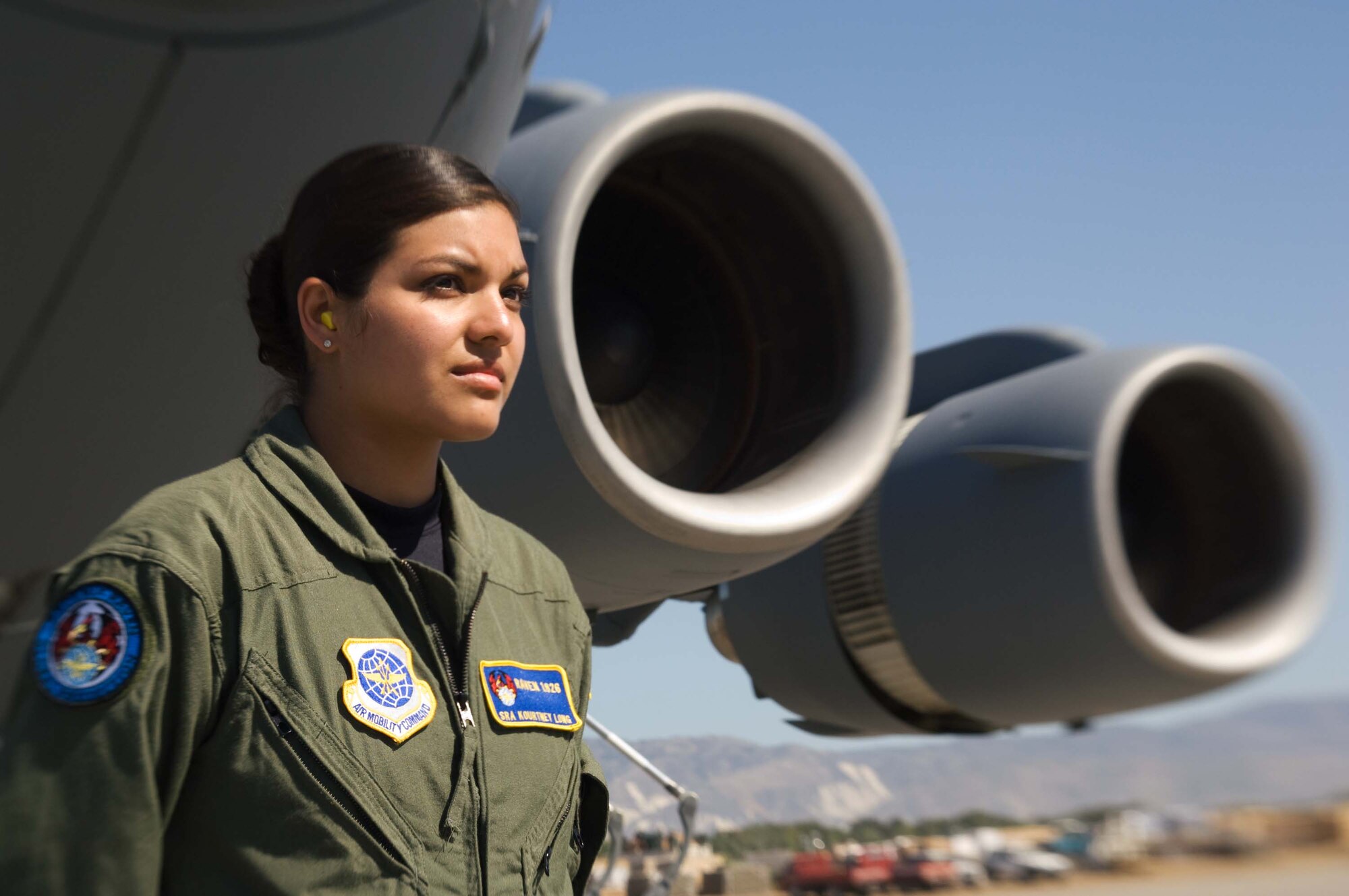 Senior Airman Kourtney Long guards a C-17 at Aeroport International Toussaint Louverture in Port-au-Prince, Haiti, Jan. 28. Airman Long is a 6th Security Forces Squadron Phoenix Raven from McDill Air Force Base, Fla. Security forces Airmen who become Ravens have been through a screening process to include reviewing Enlisted Performance Reports, standardization and evaluation reports, a physical fitness test and a 45-day apprentice course before going to the official Phoenix Raven school. (U.S. Air Force photo/Staff Sgt. Barry Loo)