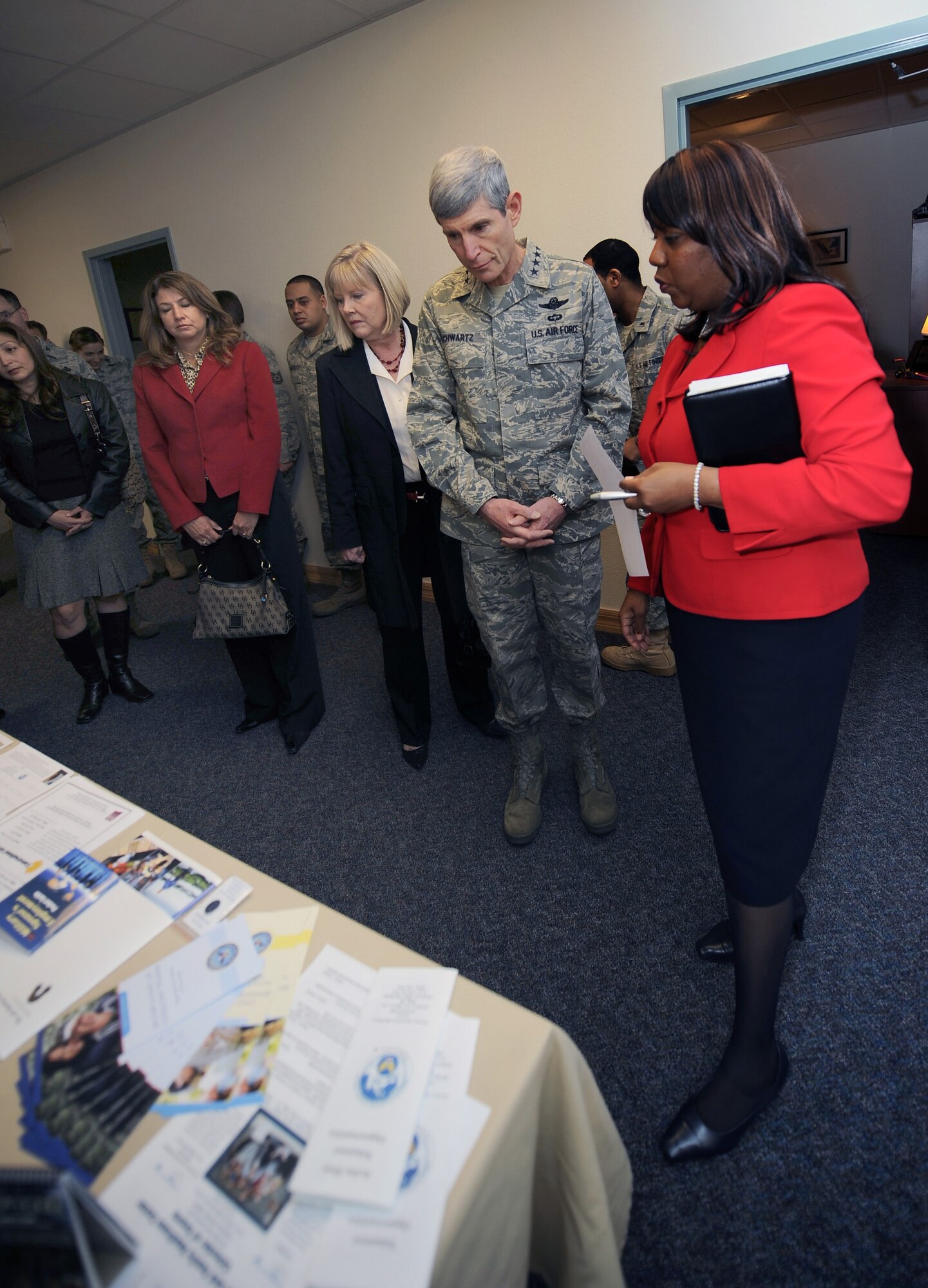 HOLLOMAN AIR FORCE BASE, N.M. -- Air Force Chief of Staff Gen. Norton Schwartz looks at programs the Airman and Family Readiness Center offer as Shirley Bratton, A&FRC director, describes them, Jan. 27. General Schwartz visited Holloman to see Airmen and operations first-hand. (U.S. Air Force photo by Airman 1st Class Veronica Stamps)