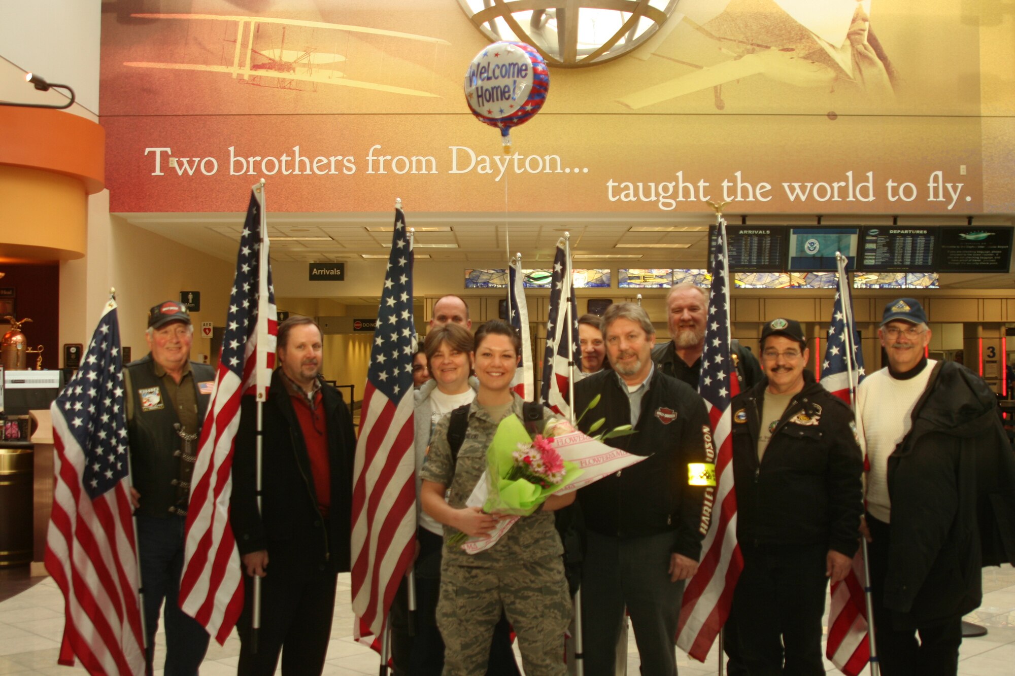 WRIGHT-PATTERSON AIR FORCE BASE, Ohio – Staff Sgt. Rachael Bieniecki, 445th Operations Support Squadron, poses for a photograph with the Ohio Patriot Guard Riders at the Dayton International Airport Jan. 27 after returning from a deployment to Al Udeid Air Base, Qatar. (U.S. Air Force photo/Master Sgt. John Koehl)