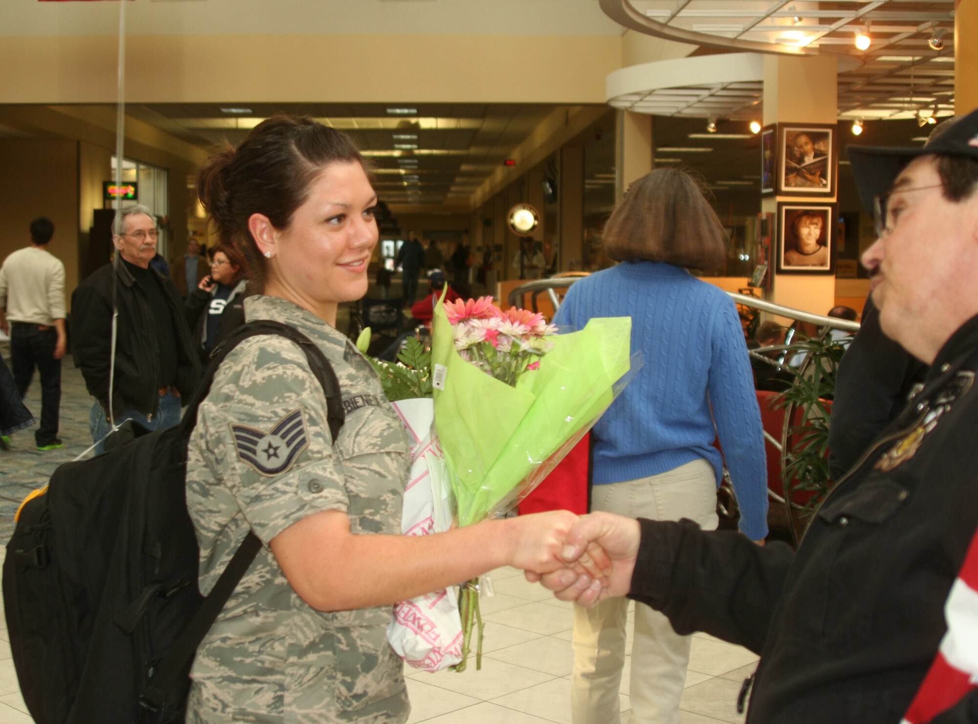 WRIGHT-PATTERSON AIR FORCE BASE, Ohio – Staff Sgt. Rachael Bieniecki, 445th Operations Support Squadron, is greeted by family, friends and members of the Ohio Patriot Guard Riders at the Dayton International Airport Jan. 27 after returning from a deployment to Al Udeid Air Base, Qatar. (U.S. Air Force photo/Master Sgt. John Koehl)