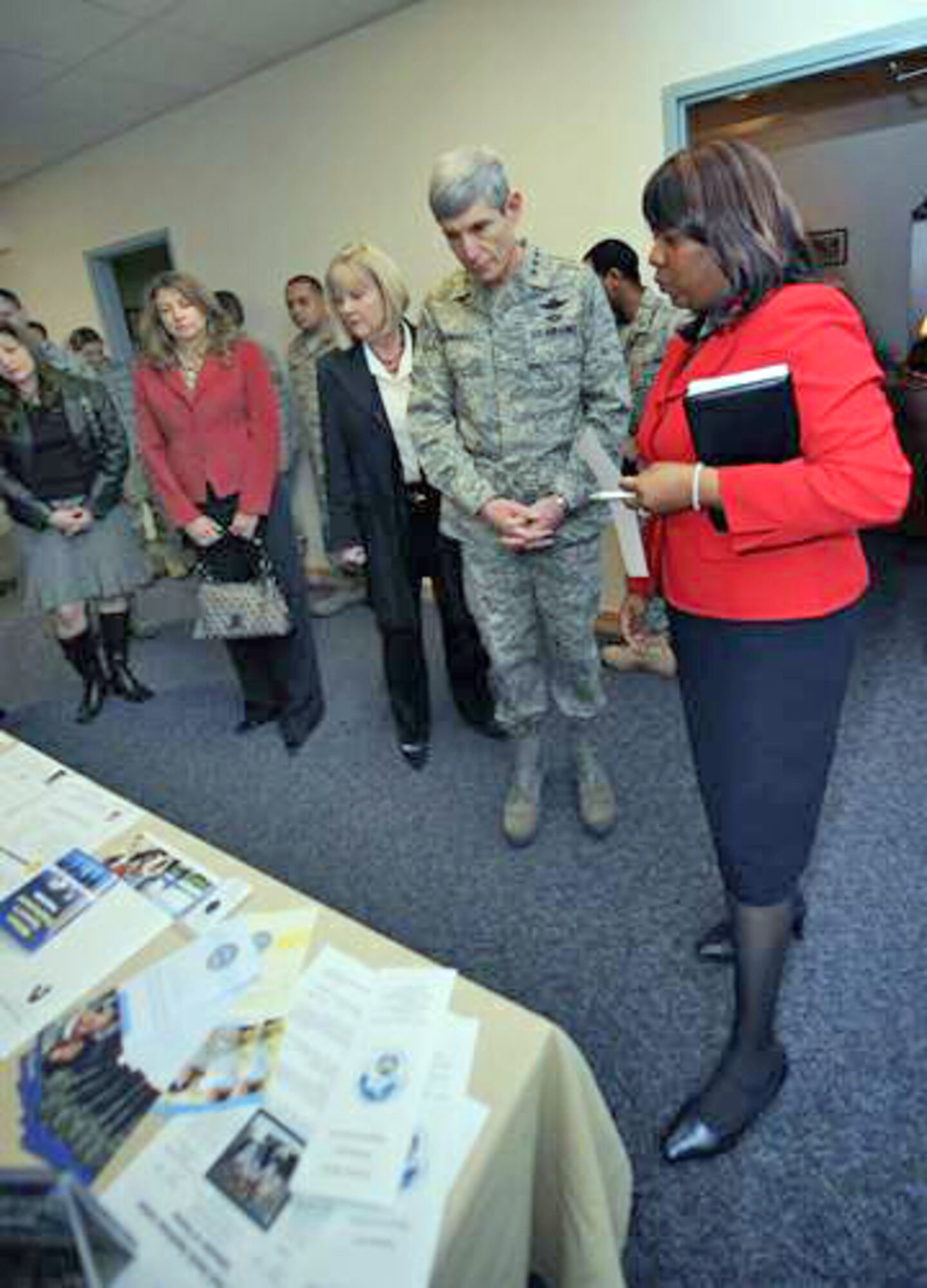 Air Force Chief of Staff Gen. Norton Schwartz looks at programs the Airman and Family Readiness Center offer as Shirley Bratton describes them Jan. 27, 2010, at Holloman Air Force Base, N.M. General Schwartz visited Holloman AFB to see Airmen and operations firsthand. Ms. Bratton is the Airman and Family Readiness Center director. (U.S. Air Force photo/Airman 1st Class Veronica Stamps)
