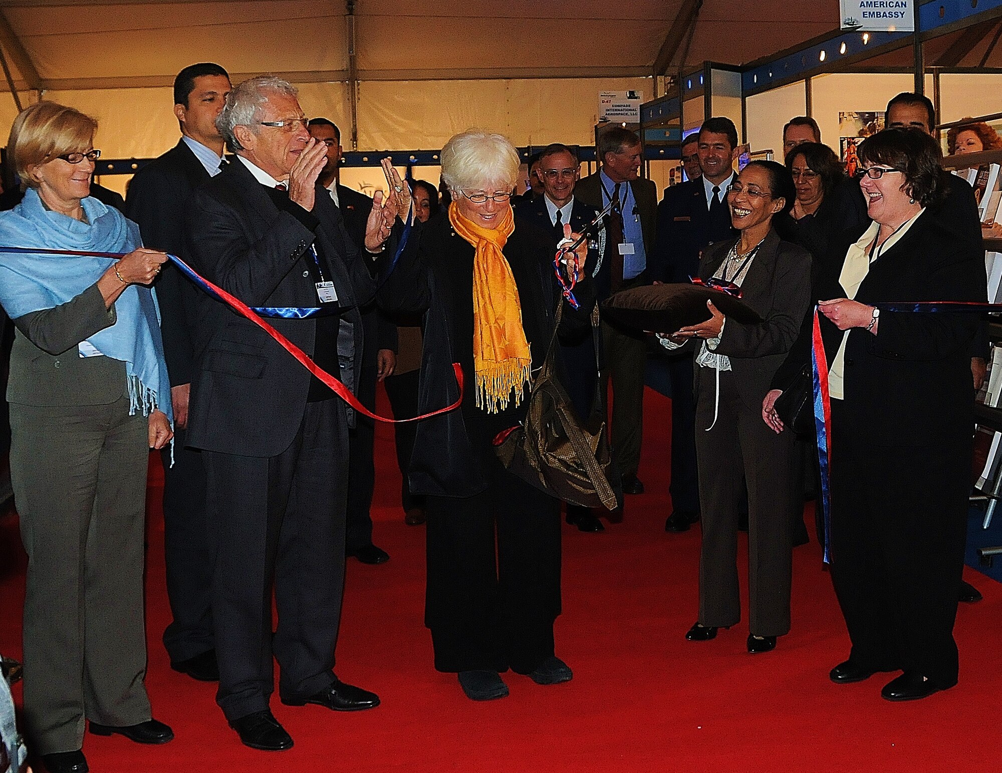MARRAKECH, Morocco -- Mrs. Silvia Kaplain, wife of the U.S. Ambassador to Morocco, Mr. Sam. Kaplan, cuts the ribbon to the opening of the U.S. Embassy pavilion Jan. 27 at the Marrakech Aeroexpo 2010. The pavilion holds all of the U.S. industry displays including a U.S. Embassy section. The purpose of the Aeroexpo is to build on relationships and to bring major players in the aeronautics industry to showcase their aviation technology. (U.S. Air Force photo by Staff Sgt. Stefanie Torres)