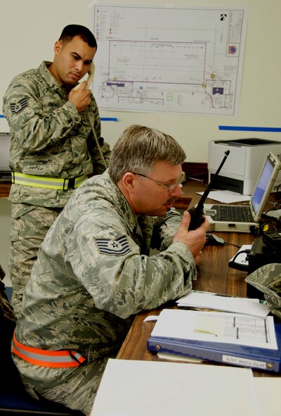 U.S. Air Force Staff Sgt. Jimenez, assigned to the 156th Airlift Wing, Puerto Rico Air National Guard, and Tech. Sgt. Dave Carpenter 133rd Airlift Wing, Minnesota Air National Guard work together in the Maintenance Operations Center at Volk Field Air National Guard Base, Wis., Jan. 26, 2010, during an operational readiness exercise. (DoD photo by Tech. Sgt. Erik Gudmundson, U.S. Air Force/Released) 