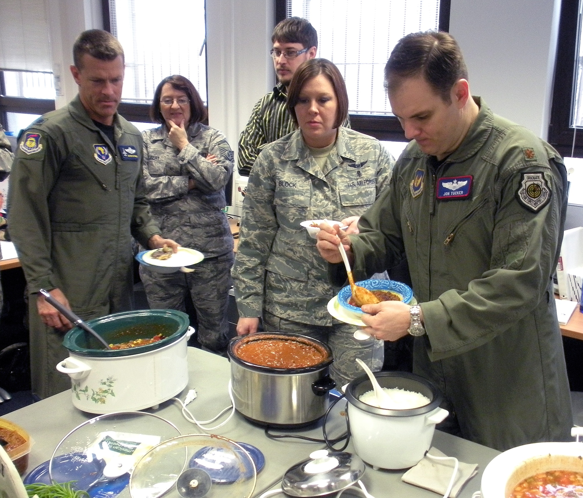 RAMSTEIN AIR BASE, Germany -- (From left to right) The 617th Air and Space Operations Center's Lt. Col. Deron Reynolds and Master Sgt. Mary Hilbert join 603th Air and Space Operations Center counterparts Rob Murphy, Master Sgt. Misty Block and Maj. Jonathan Tucker in trying to determine which chili is the best, hottest and most original during the 617th’s Chili Cook-off Jan. 29 here. The 617th relied heavily on the 603rd for support while building their facility and capabilities as the AOC for 17th Air Force (Air Forces Africa). The 617th held the cook-off for their guests from the 603rd to show appreciation for all the assistance they received. Until the 617th facilities opened earlier this month in the 17th AF HQ, both units conducted operations from the 603rd's Ramstein facilities. The AOC’s also shared training and operational expertise as the 617th prepared to assume command and control responsibilities in the African area of activity. 

In addition to food and festivities, the 617th offered a tour of their new AOC. (U.S. Air Force photo by Master Sgt. Jim Fisher)
