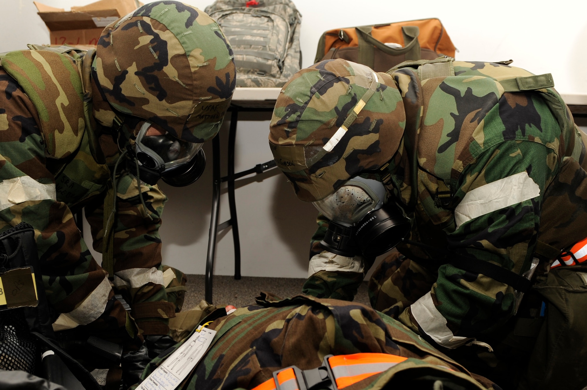 SCOTT AIR FORCE BASE, Ill. – Airmen practice their Self Aid Buddy Care as their Wingman lays on the floor With a head wound January 25, 2010 during the Operational Readiness Exercise held at Volk Field Combat Readiness and Training Center, Wis. During the ORE Airmen were able to work on fine-tuning their combat skIll.s in preparation for the Operational Readiness Inspection in March. (U.S. Air Force photo/Senior Airman Wesley Farnsworth)