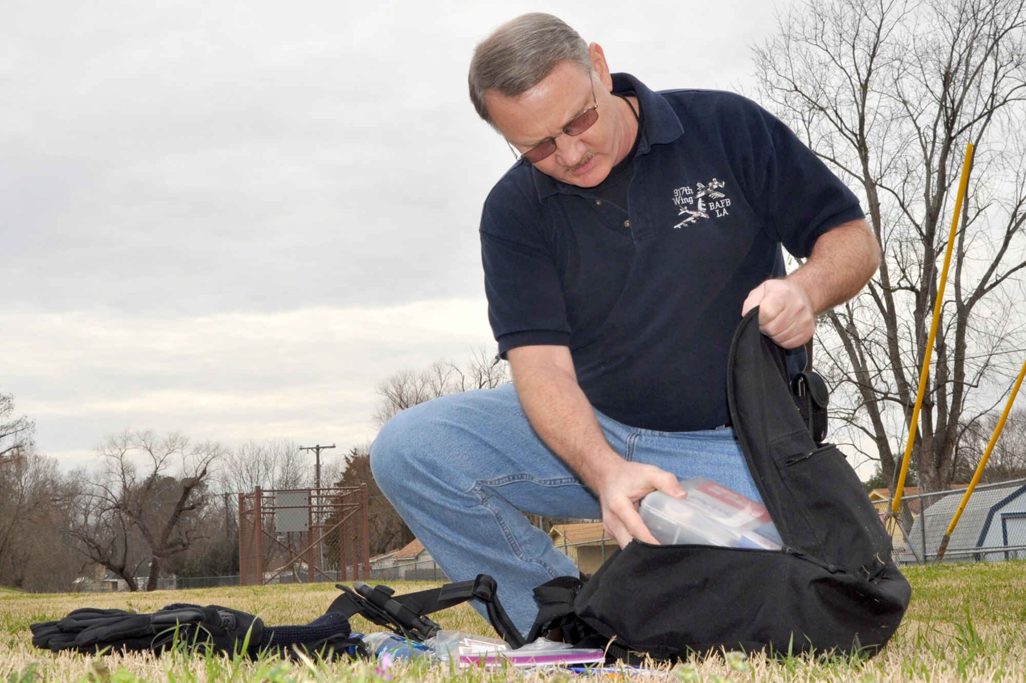 Tech. Sgt. Jeff Walston, the acting chief of public affairs for the 917th Wing on Barksdale Air Force Base, La., places a first-aid kit into his survival bag on Jan. 27, 2010. Sergeant Walston, an avid traveler, regularly carries a survival kit in his vehicle.  However, after experiencing a series of inclement weather events on Barksdale and witnessing natural disasters across the globe, he added to his simple set of items in his kit and now keeps it with him at all times. Items such as snacks, bottles of water and a first-aid kit will ensure he has what he needs while relief efforts are underway. Specific to him, is a knife, gloves and appropriate seasonal clothing. Survival kits will be different for each person depending on the basics needs and situation of that person. The all inclusive fact is, like Sergeant Walston, everyone must be prepared. (U.S. Air Force Photo/Senior Airman Crystal Marie Jordan)