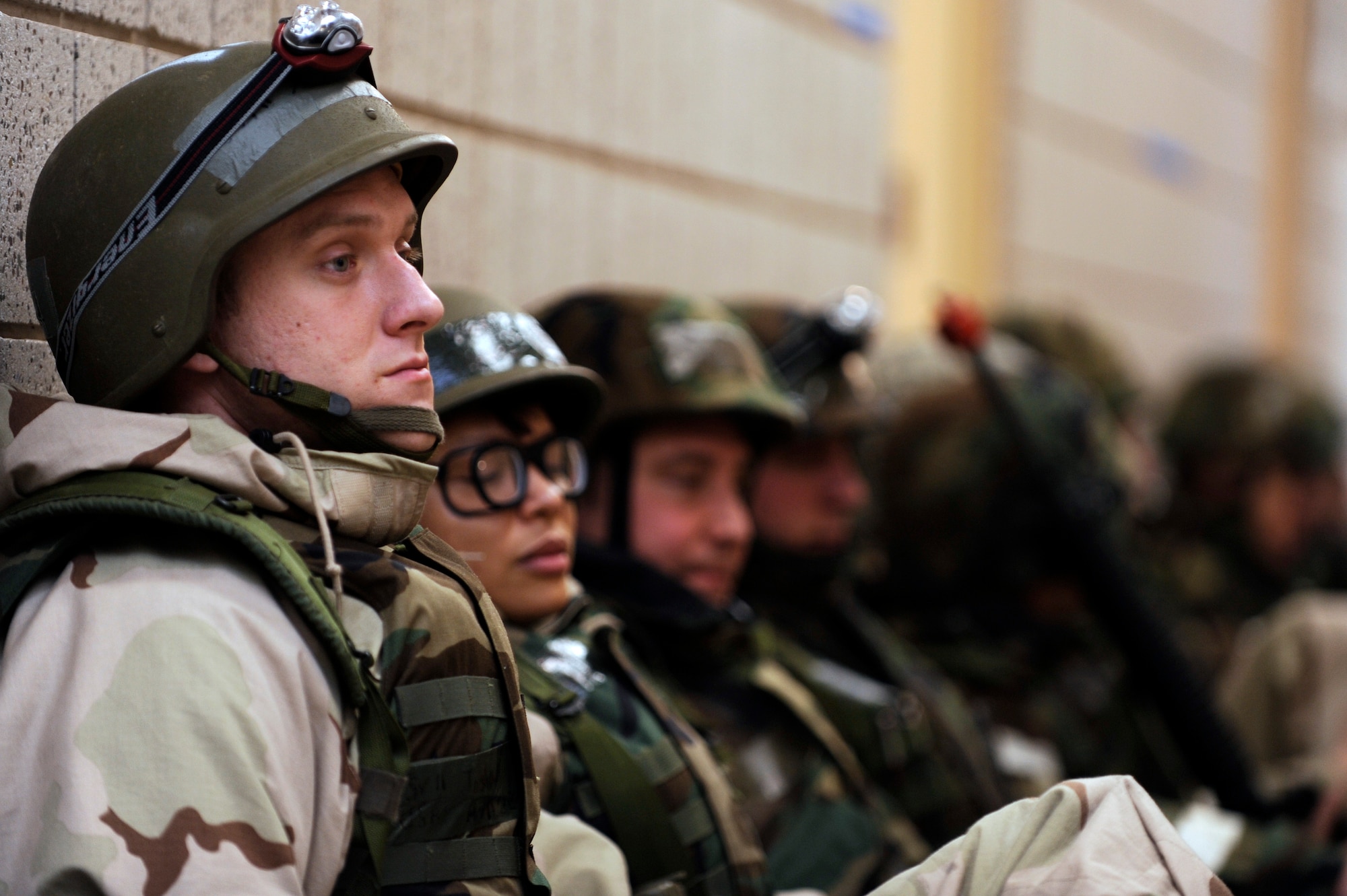 SCOTT AIR FORCE BASE, Ill. – Senior Airman Josh Hartline, 375th Operations Support Squadron weather forecaster, sits with other Airman in the halls while waiting for the “all clear” to return to their work centers January 25, 2010, as part of the Operational Readiness Exercise at Volk Field Combat Readiness and Training Center, Wis. During the ORE Airmen were able to work on fine-tuning their combat skills in preparation for the Operational Readiness Inspection in March. (U.S. Air Force photo/Senior Airman Wesley Farnsworth)