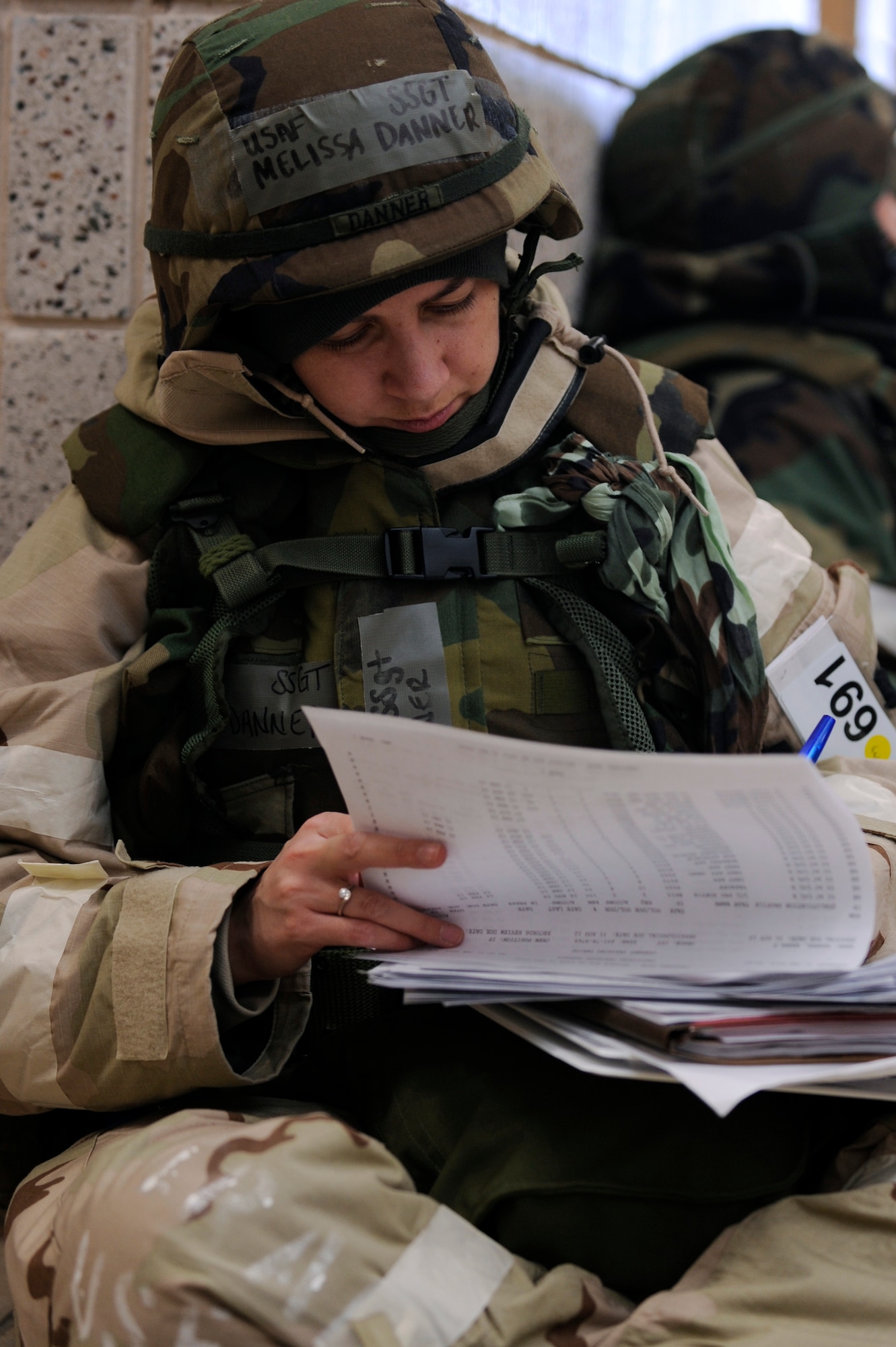 SCOTT AIR FORCE BASE, Ill. – Staff Sgt. Melissa Danner, 458th Airlift Squadron aviation resource manager, goes over equipment paperwork while in mission oriented protective posture 4, January 25, 2010, as part of the Operational Readiness Exercise at Volk Field Combat Readiness and Training Center, Wis. During the ORE Airmen were able to work on fine-tuning their combat skills in preparation for the Operational Readiness Inspection in March. (U.S. Air Force photo/Senior Airman Wesley Farnsworth)