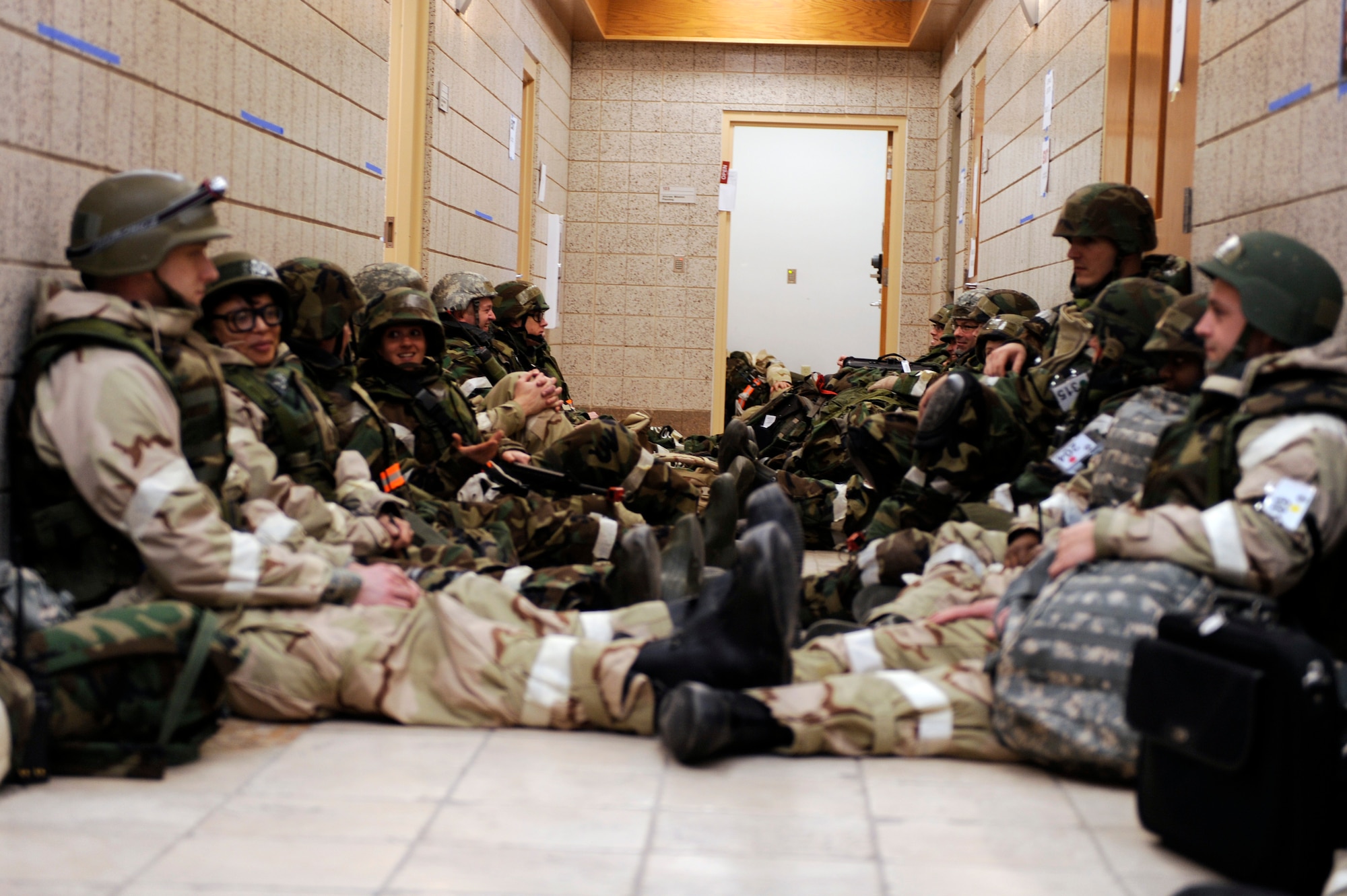 SCOTT AIR FORCE BASE, Ill. -- Airmen seek safety by lining the halls in the center of the building during an incoming attack January 25, 2010 as part of the Operational Readiness Exercise at Volk Field Combat Readiness and Training Center, Wis. During the ORE Airmen were able to work on fine-tuning their combat skills in preparation for the Operational Readiness Inspection in March. (U.S. Air Force photo/Senior Airman Wesley Farnsworth)