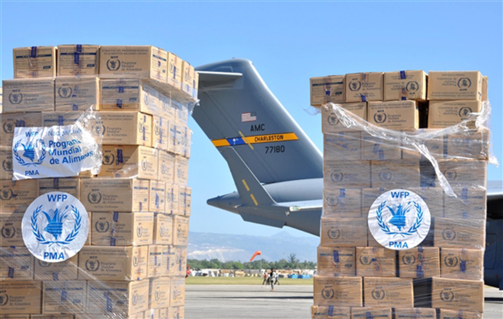 Stacks of supplies shipped by the World Food Program to Haiti frame the tail of an Air Force C-17 Globemaster III transport Jan. 19, 2010, at the airport in Port-au-Prince, Haiti. (U.S. Air Force photo/Capt. Dustin Doyle)