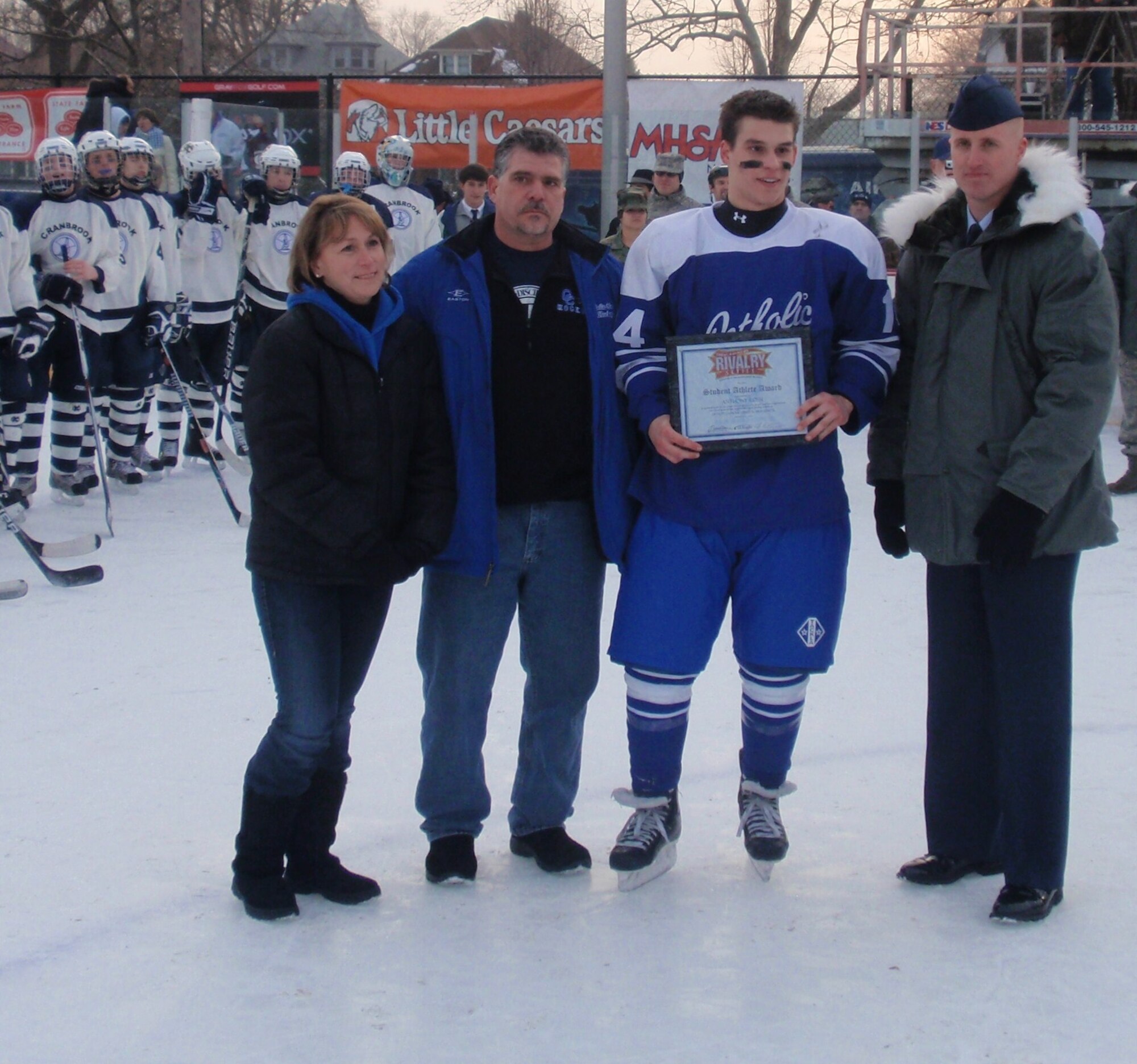Staff Sgt. Rich Rice presents Detroit Catholic Central’s Anthony Rossi, a college scholarship.  Mr. Rossi was the team’s top student-athlete. (U.S. Air Force photo/ Tech Sgt. Michael Lionberger)