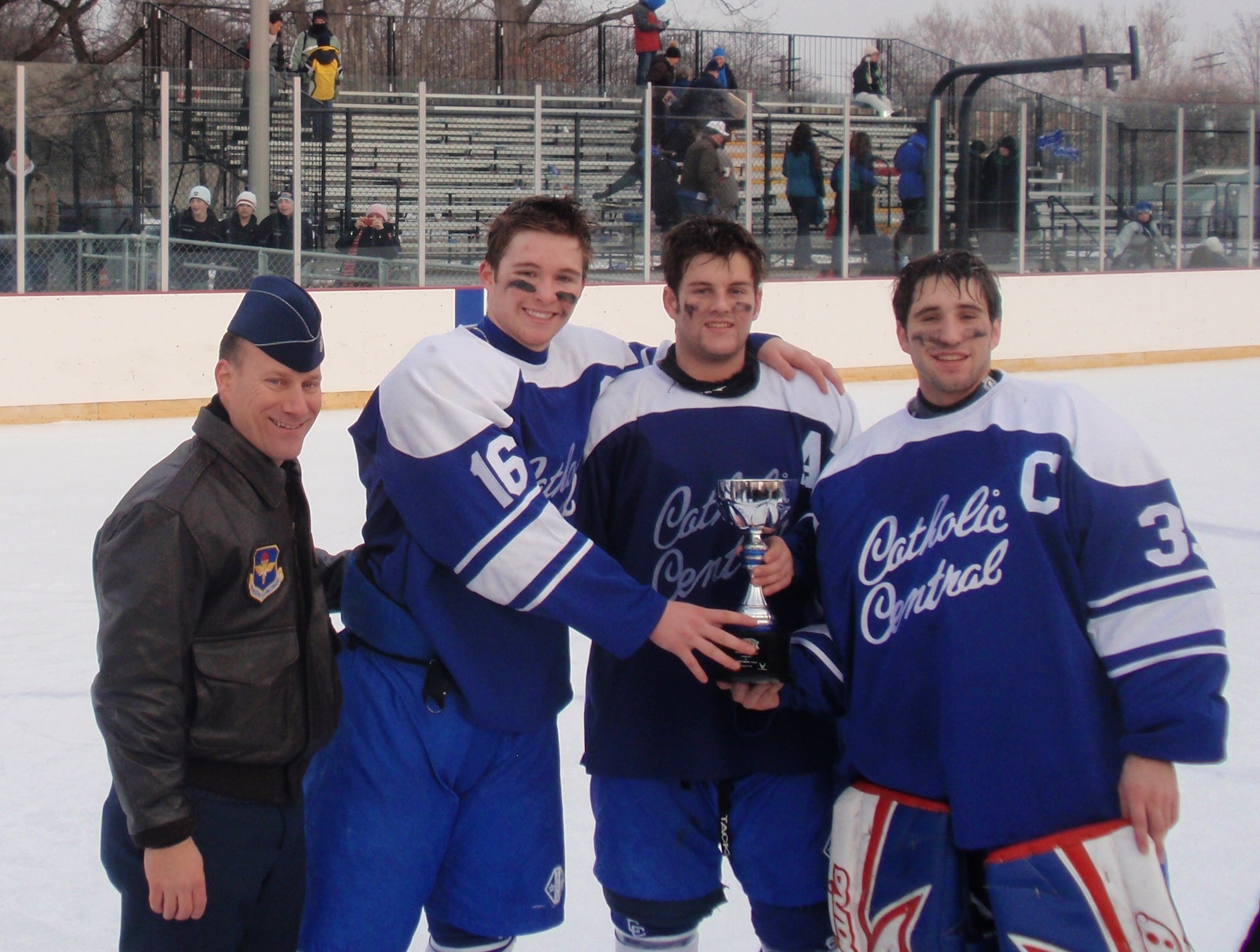 Lt. Col. Todd Weyerstrass poses with the Detroit Catholic Central team captains after awarding the Great American Rivalry Series Champion trophy. (U.S. Air Force photo/ Tech Sgt. Michael Lionberger)