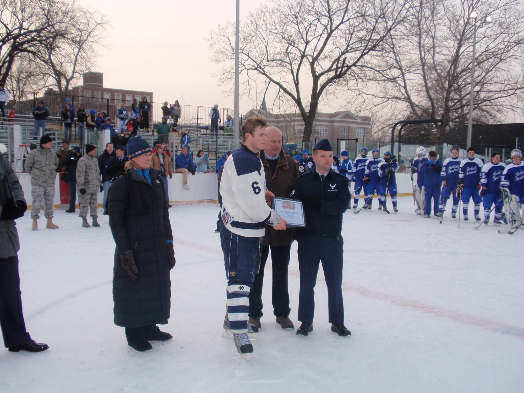 Staff Sgt. Stephen Harper presents Bloomfield Hills Cranbook Kingswood’s Kevin Collon, a college scholarship.  Mr. Collon was the team’s top student-athlete. (U.S. Air Force photo/ Tech Sgt. Michael Lionberger)