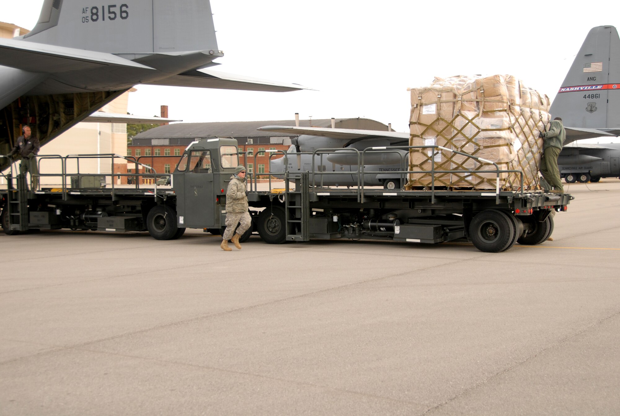 Staff Sgt. Anthony Boss, runs to help two reservists from the 403rd Wing, Keesler AFB, Miss., load pallets onto a C-130 at the 118th AW Jan. 28. The crew loaded eight of 21 pallets to be sent to Aghanistan as Humanitarian Aid. The next group of pallets is scheduled to be loaded sometime in February.